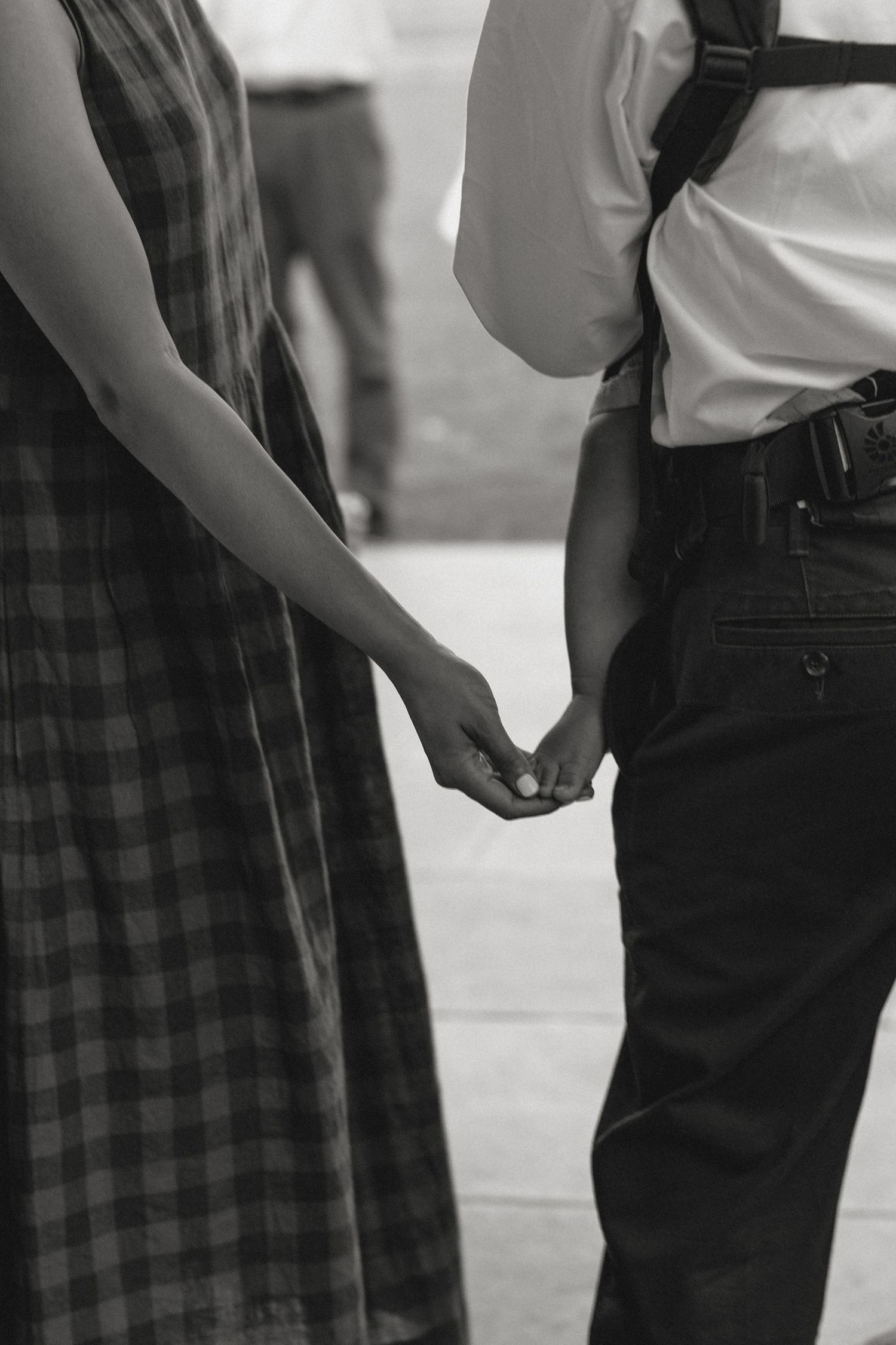 Black and white image showing close-up of casual clothing details.