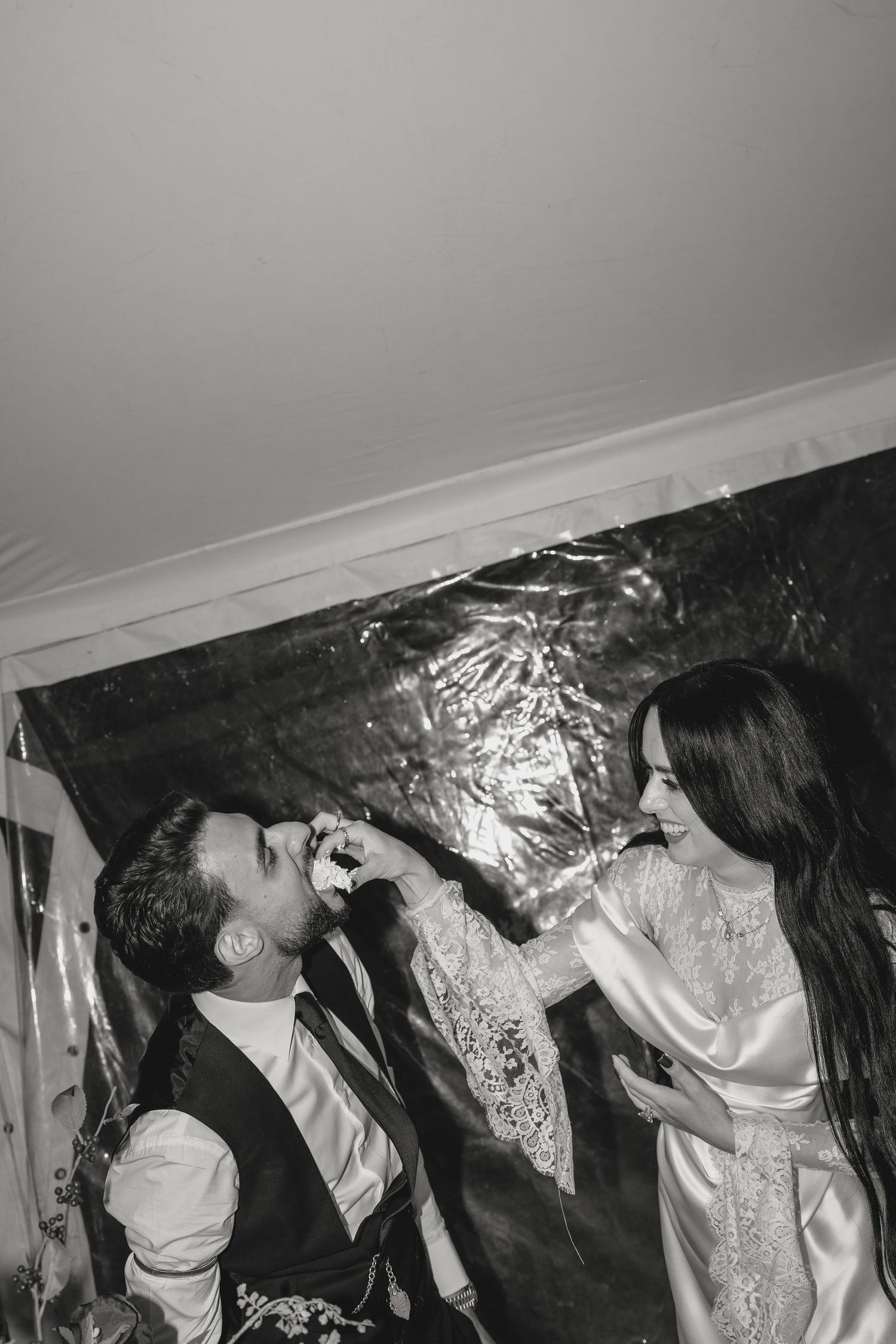An intimate black and white portrait capturing a tender moment between newlyweds.