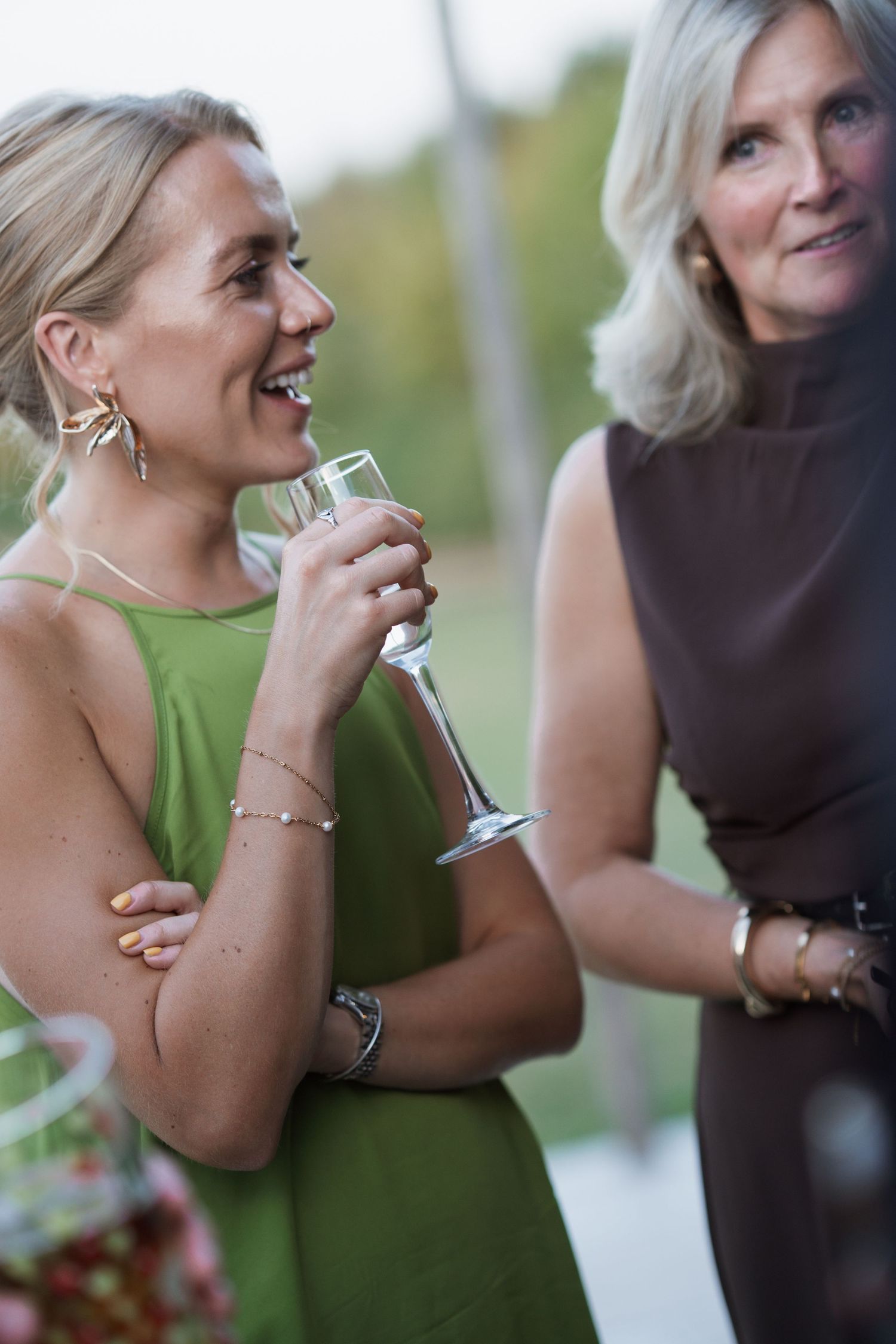 Group of guests laughing together during an outdoor celebration.