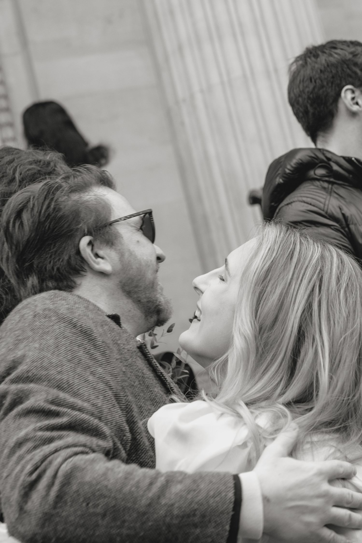 A tender emotional moment captured in black and white during a wedding ceremony.