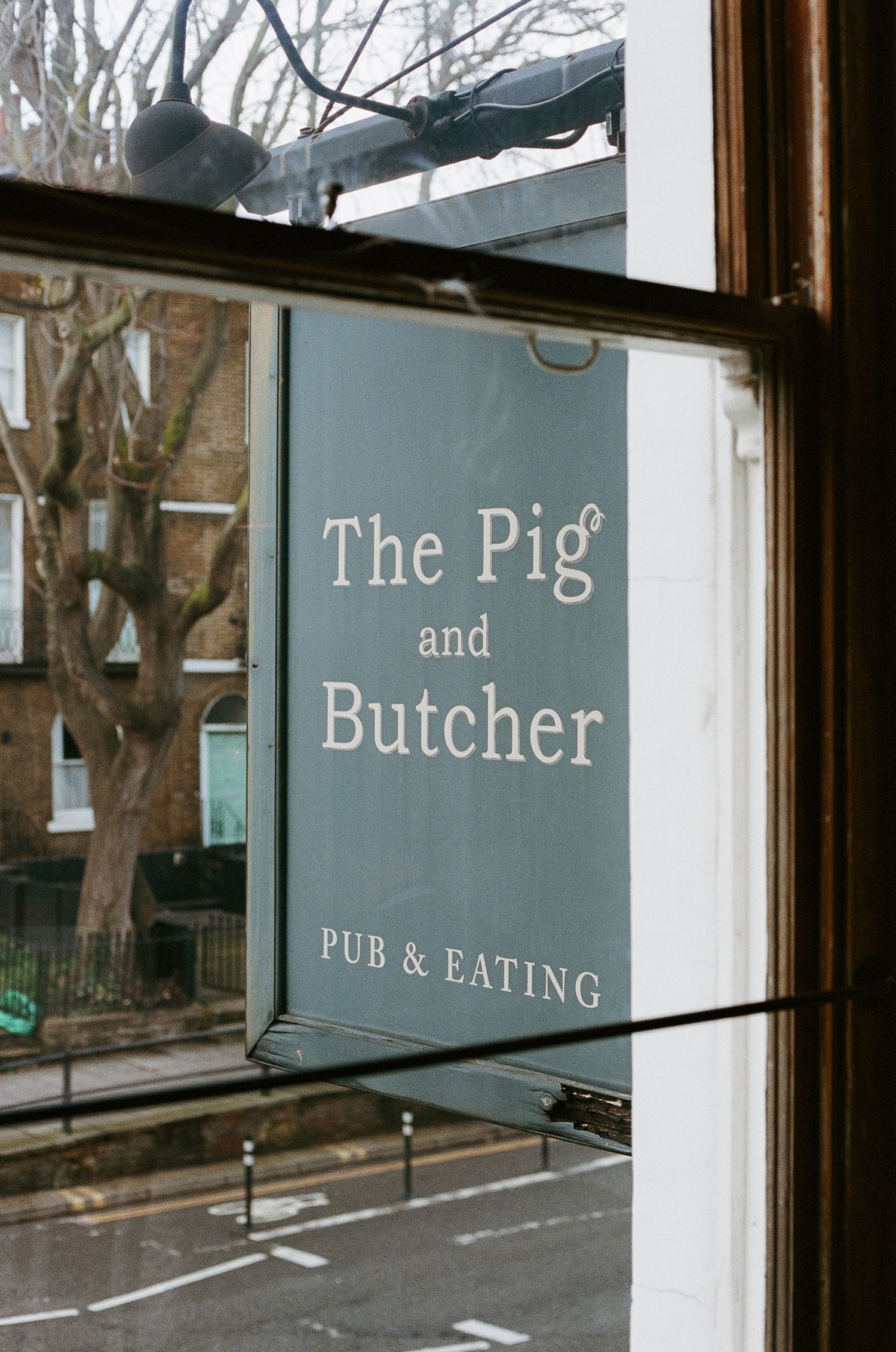 The Pig & Butcher pub and eating establishment storefront sign.