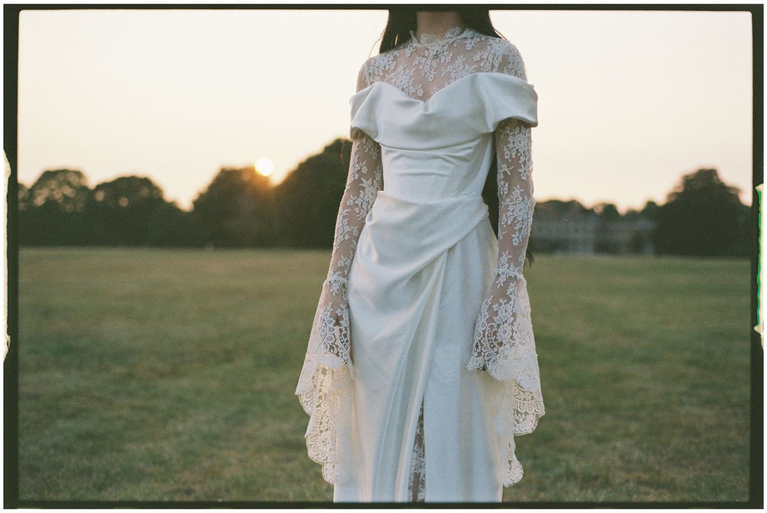 Detail shot of bride's vintage-inspired wedding dress with lace sleeves.