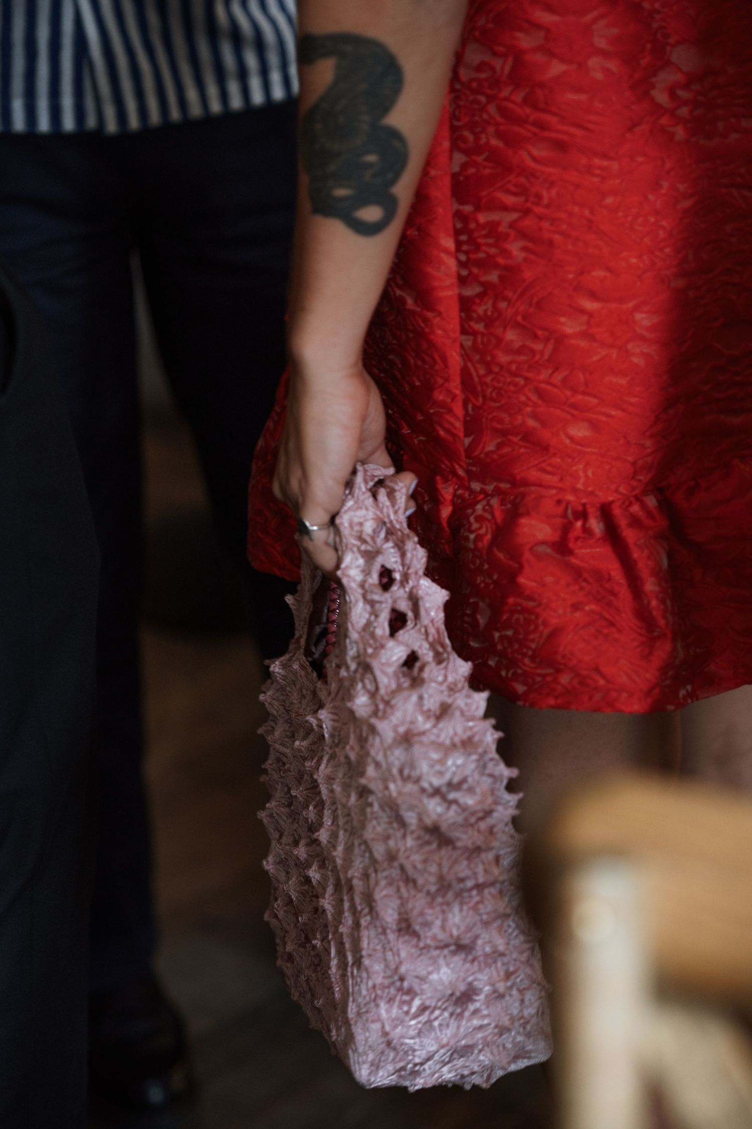 Detail shot of red dress with delicate lace trim.
