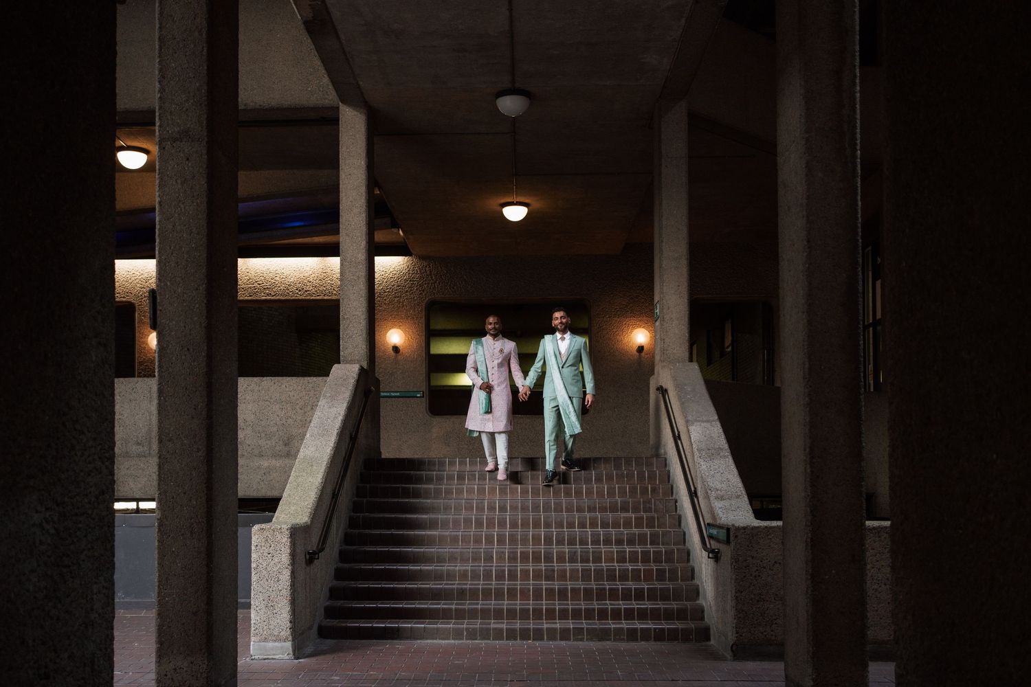 Dark interior hallway with stairs and overhead lighting creating moody atmosphere.