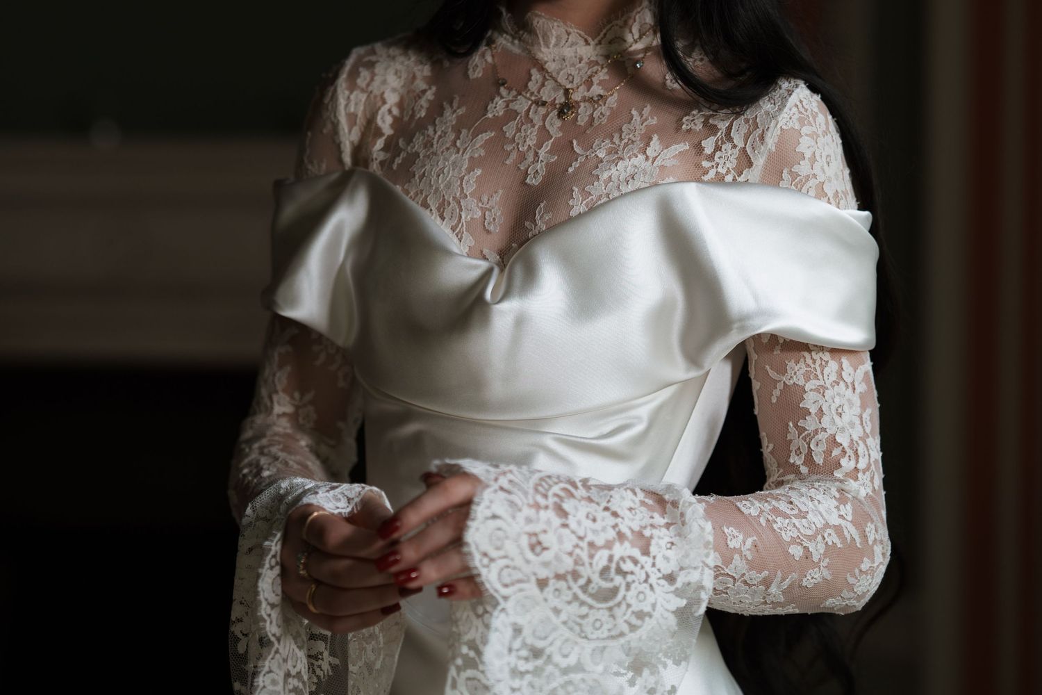 Elegant wedding dress with delicate lace sleeves and satin details.