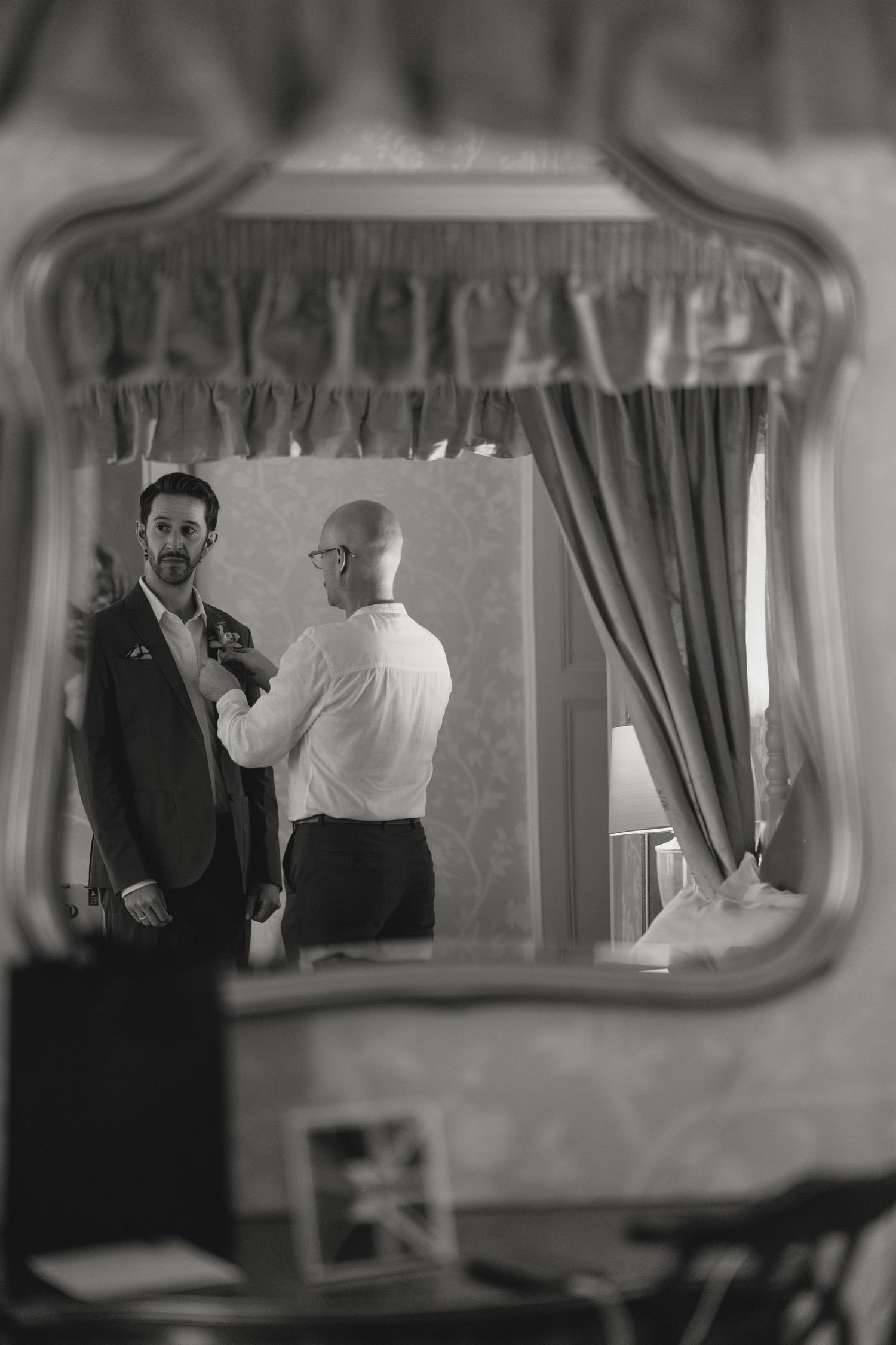 Black and white photo showing a conversation through a car window.
