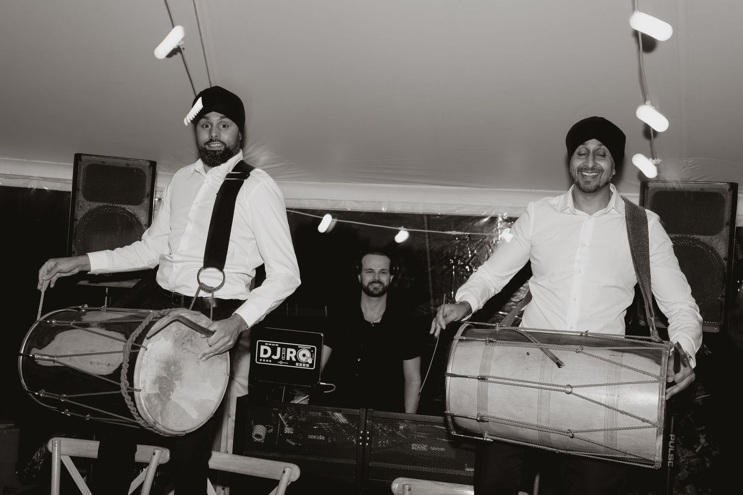 Black and white photo of entertainment equipment and performers at an event.