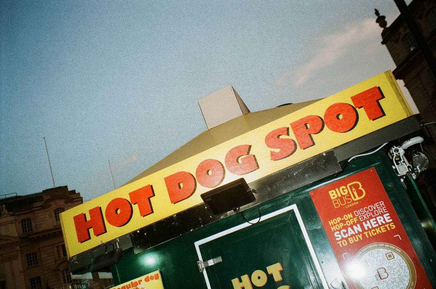 Illuminated Hot Dog Spot fast food restaurant sign at night.