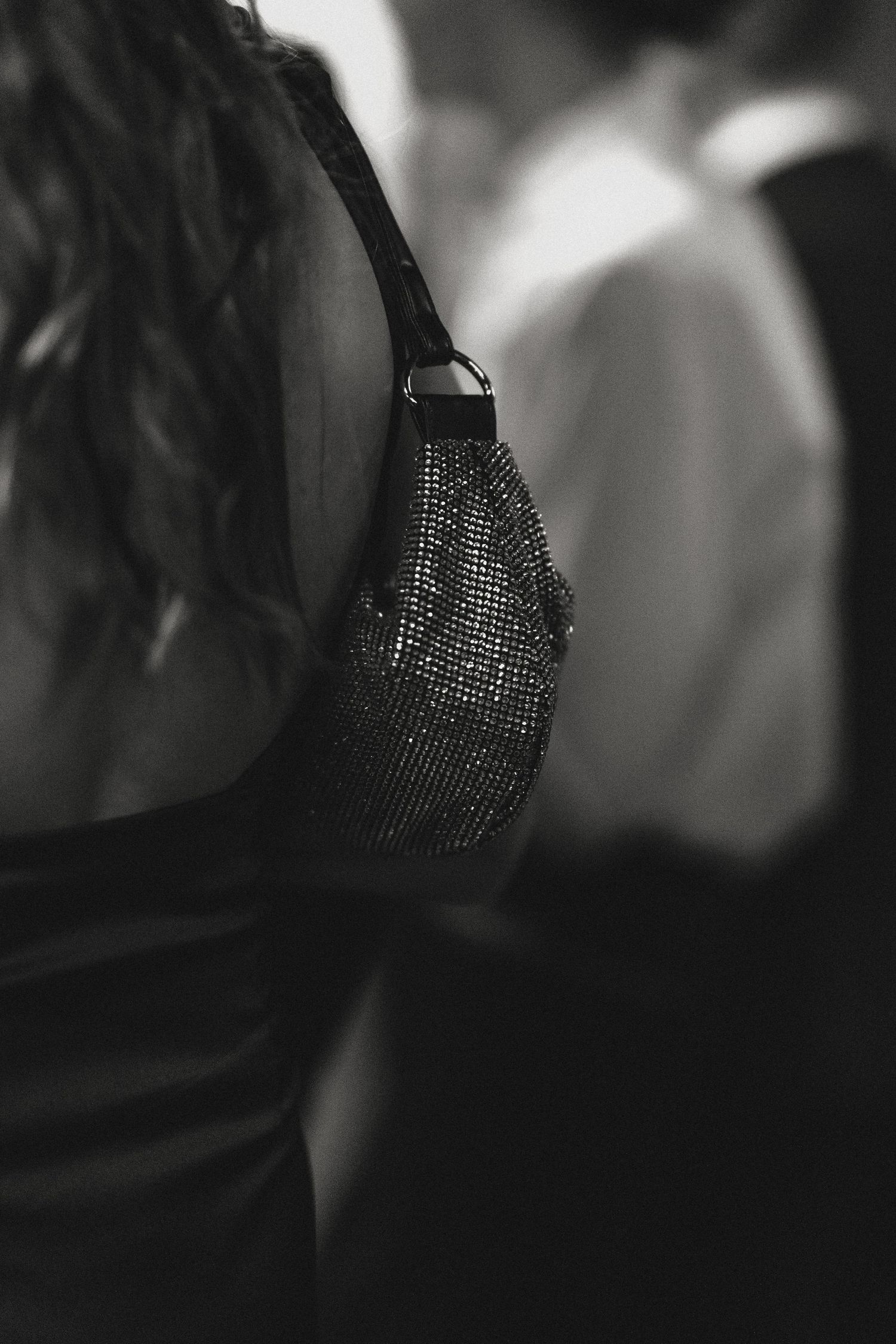 Close-up of sparkly formal evening wear in dim lighting.
