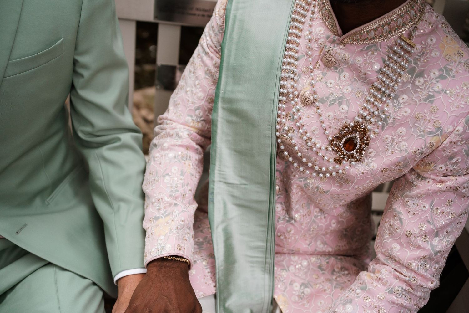 Detail shot of pink lace and mint green formal attire.