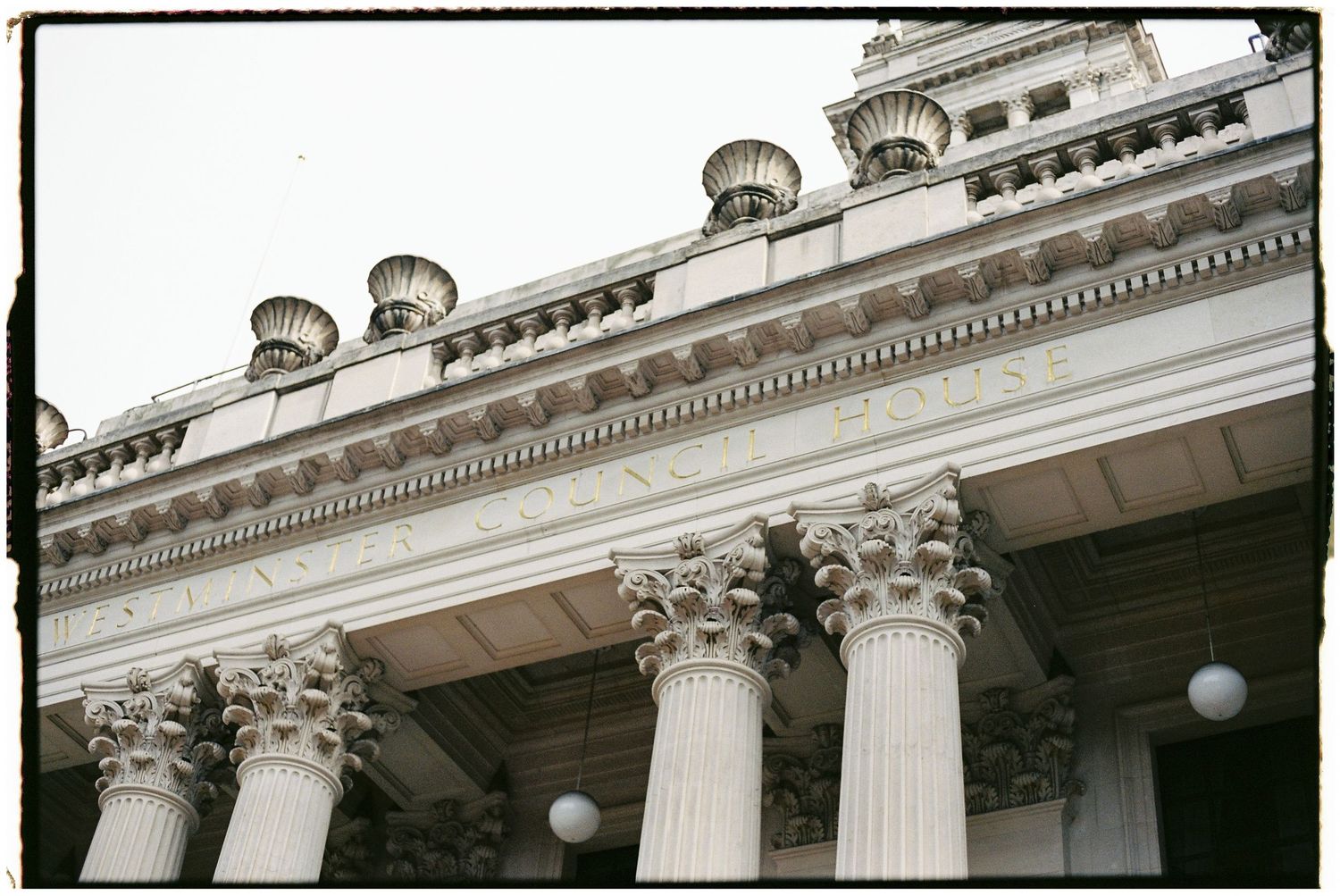 Architectural detail of ornate classical columns and cornices on a grand building facade.