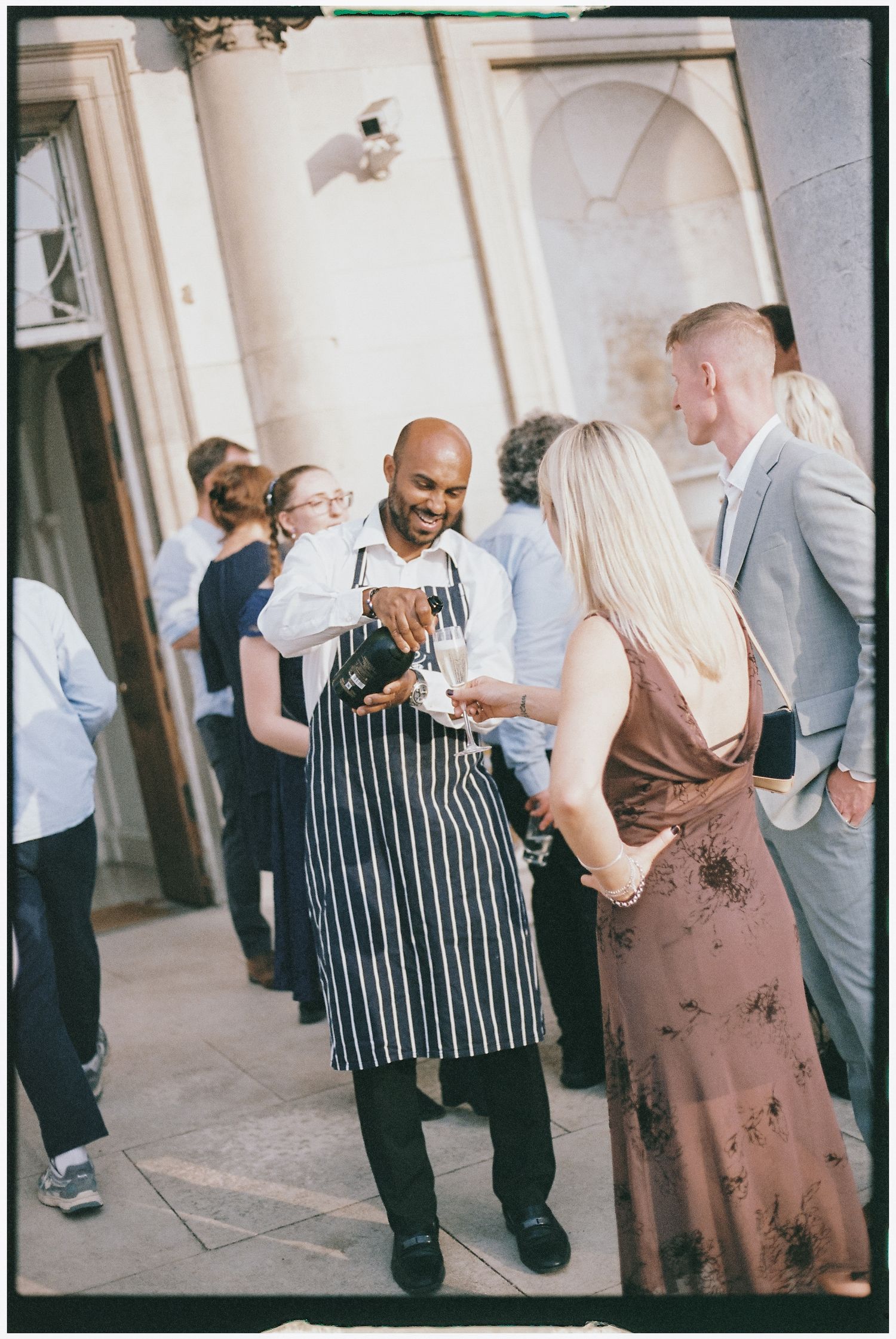 Candid moments captured at a social event with guests interacting in a bright indoor space.