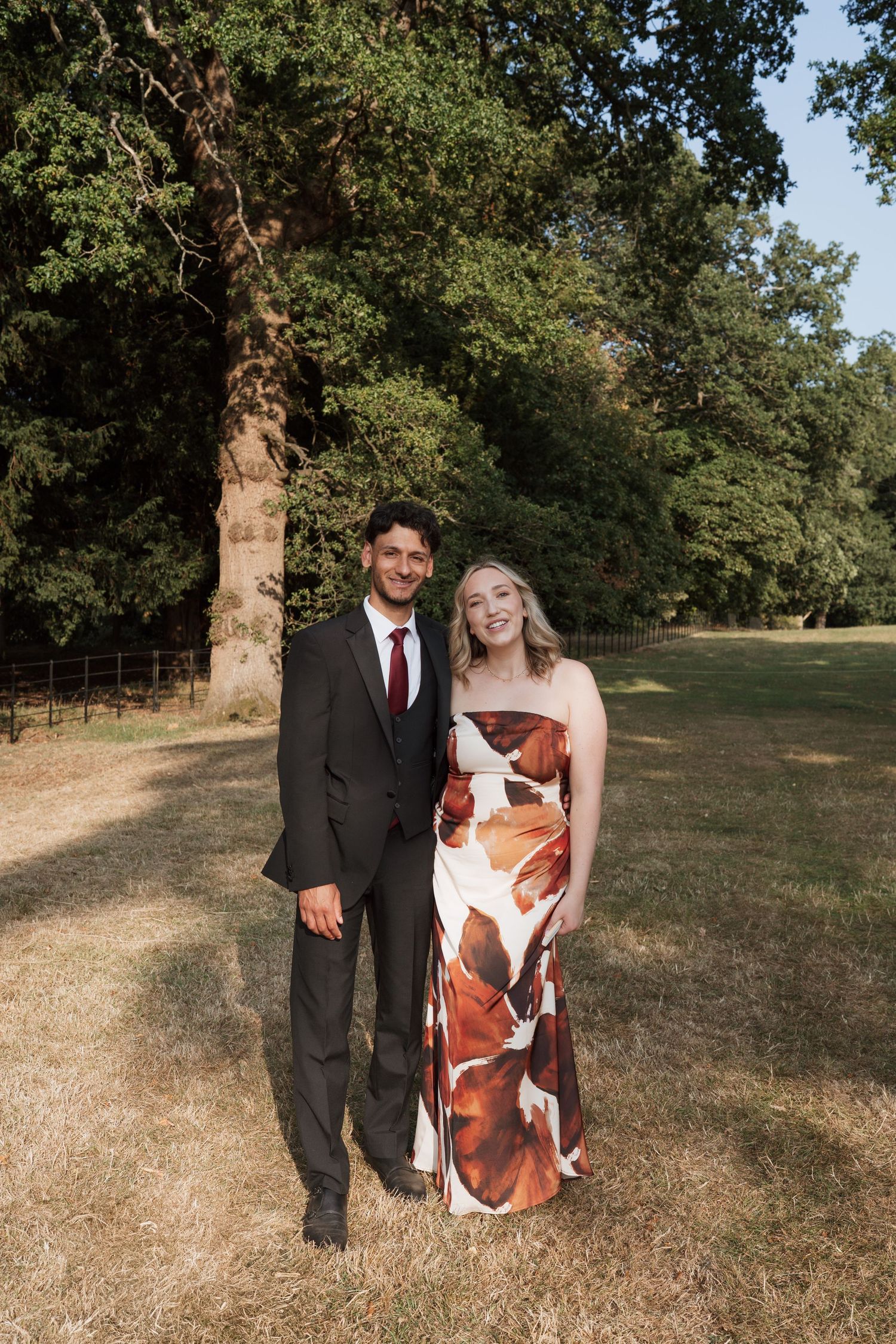 Musicians perform with a cello at an outdoor wedding ceremony.