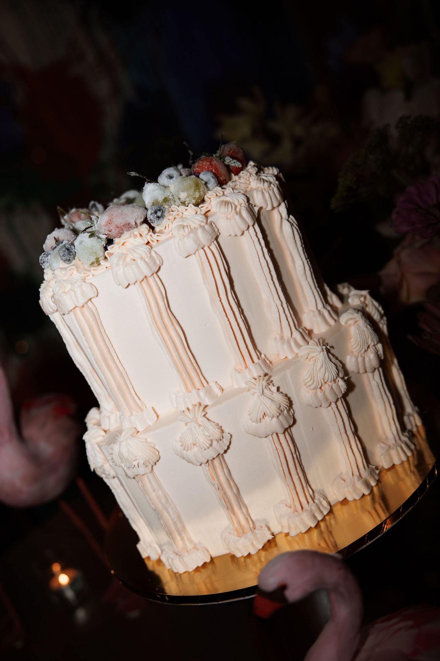 Elegant white wedding cake with intricate piped details and classic design.