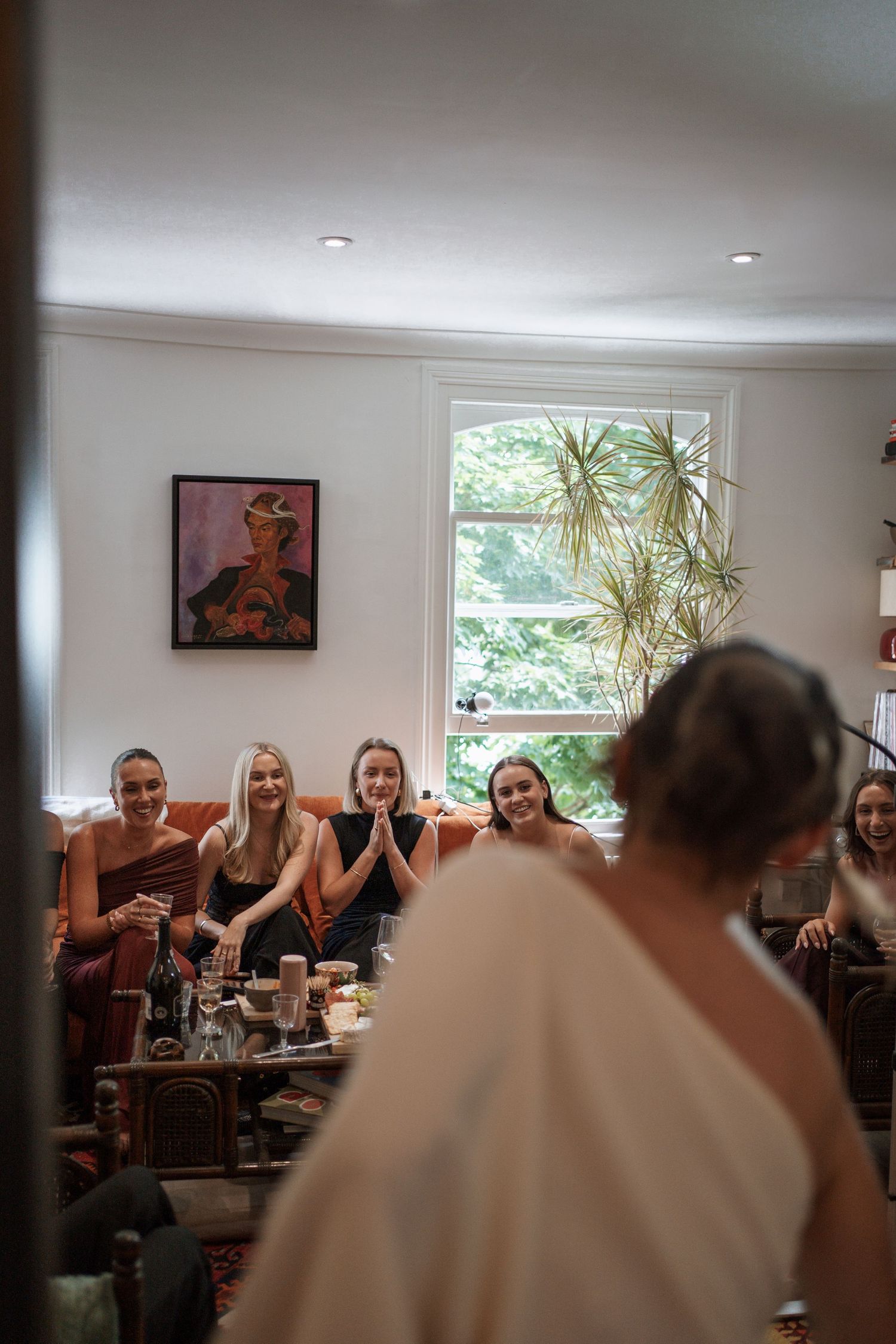 A panoramic view of guests gathered at a social event in a modern interior space.