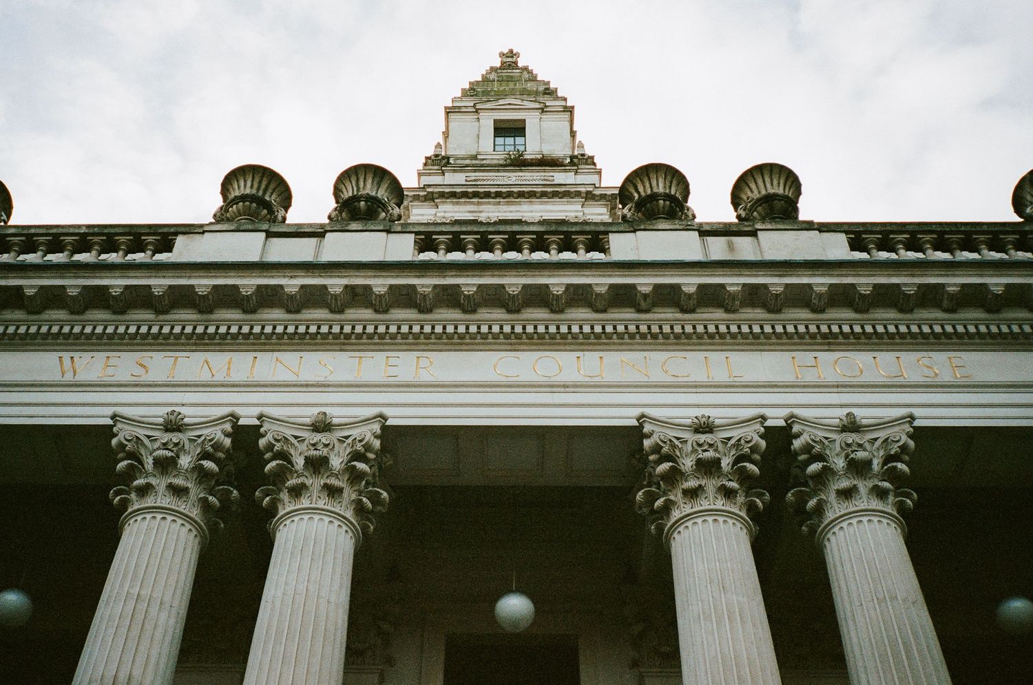 Architectural detail of a neoclassical building with grand columns and ornate roofline.