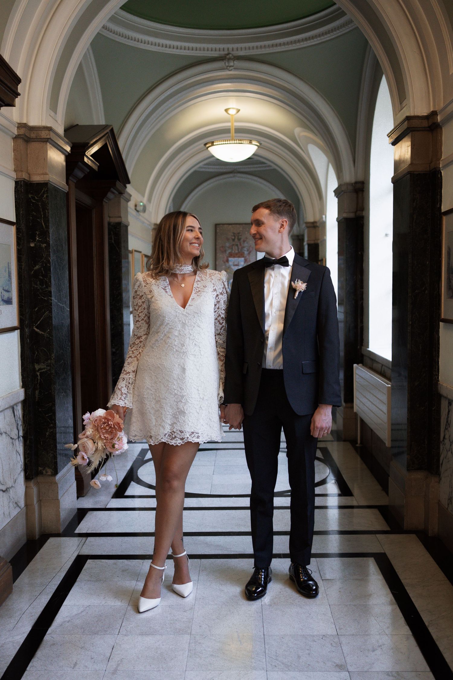 Elegant marble hallway with arched ceilings and classic architectural details.