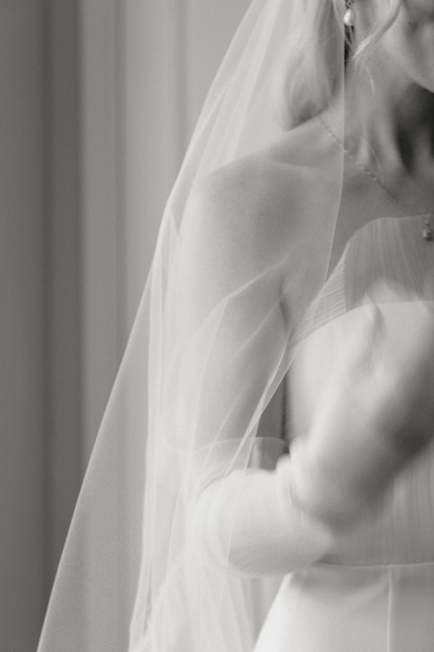 Ethereal close-up of flowing white wedding veil with soft focus effect.