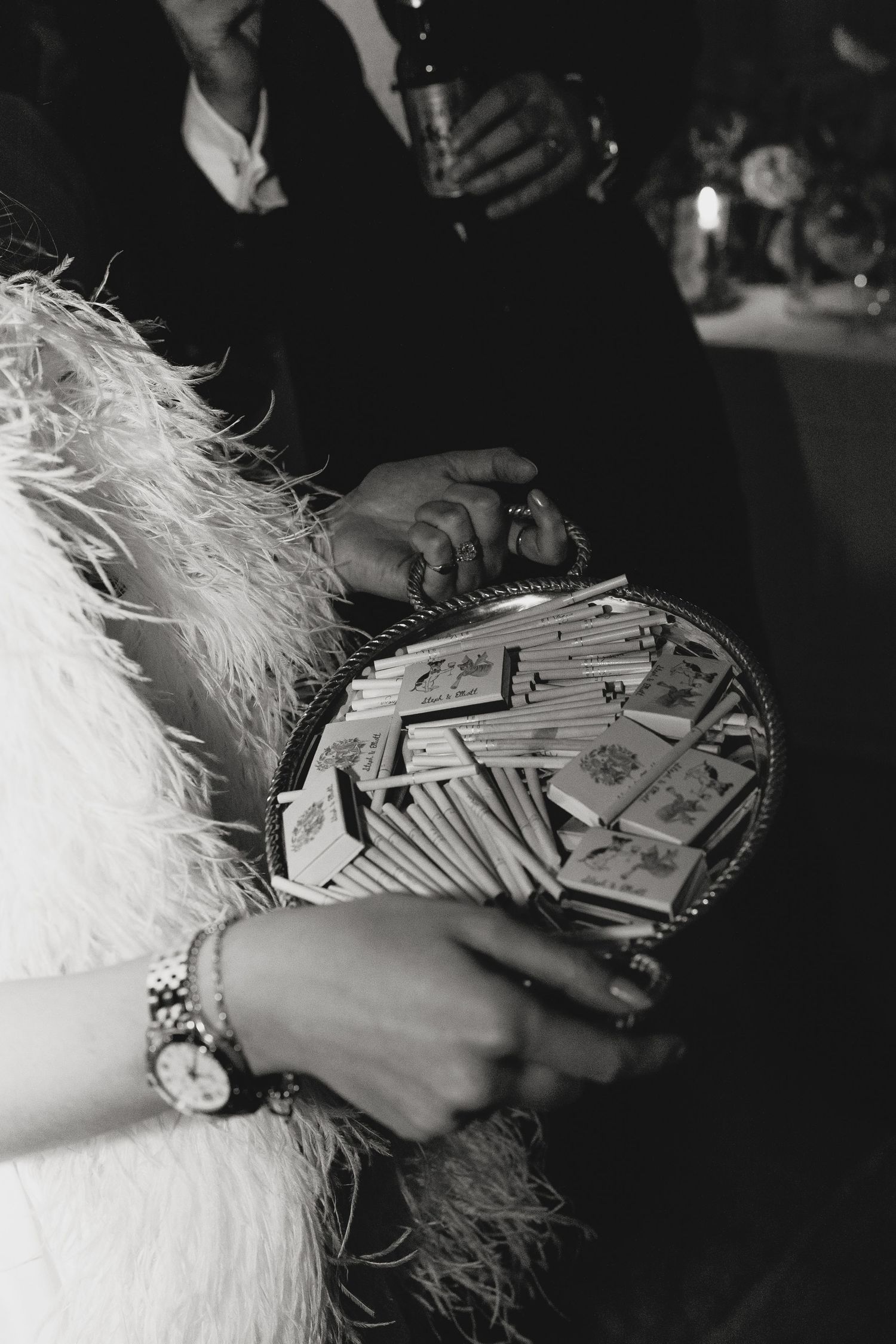 Close-up of hands holding a purse filled with cash at a formal event.