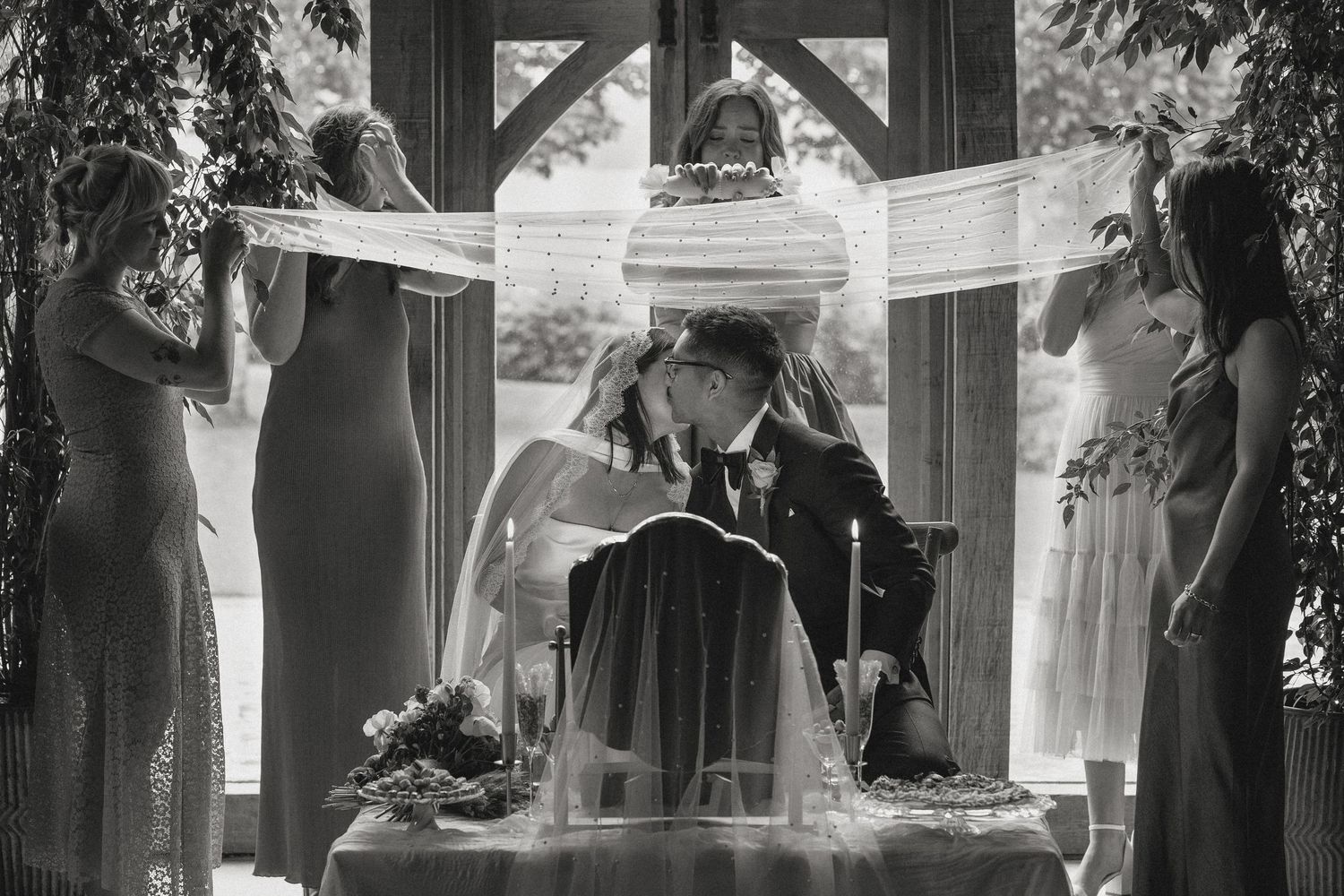 Wedding ceremony setup in a historic building with natural light streaming through windows.