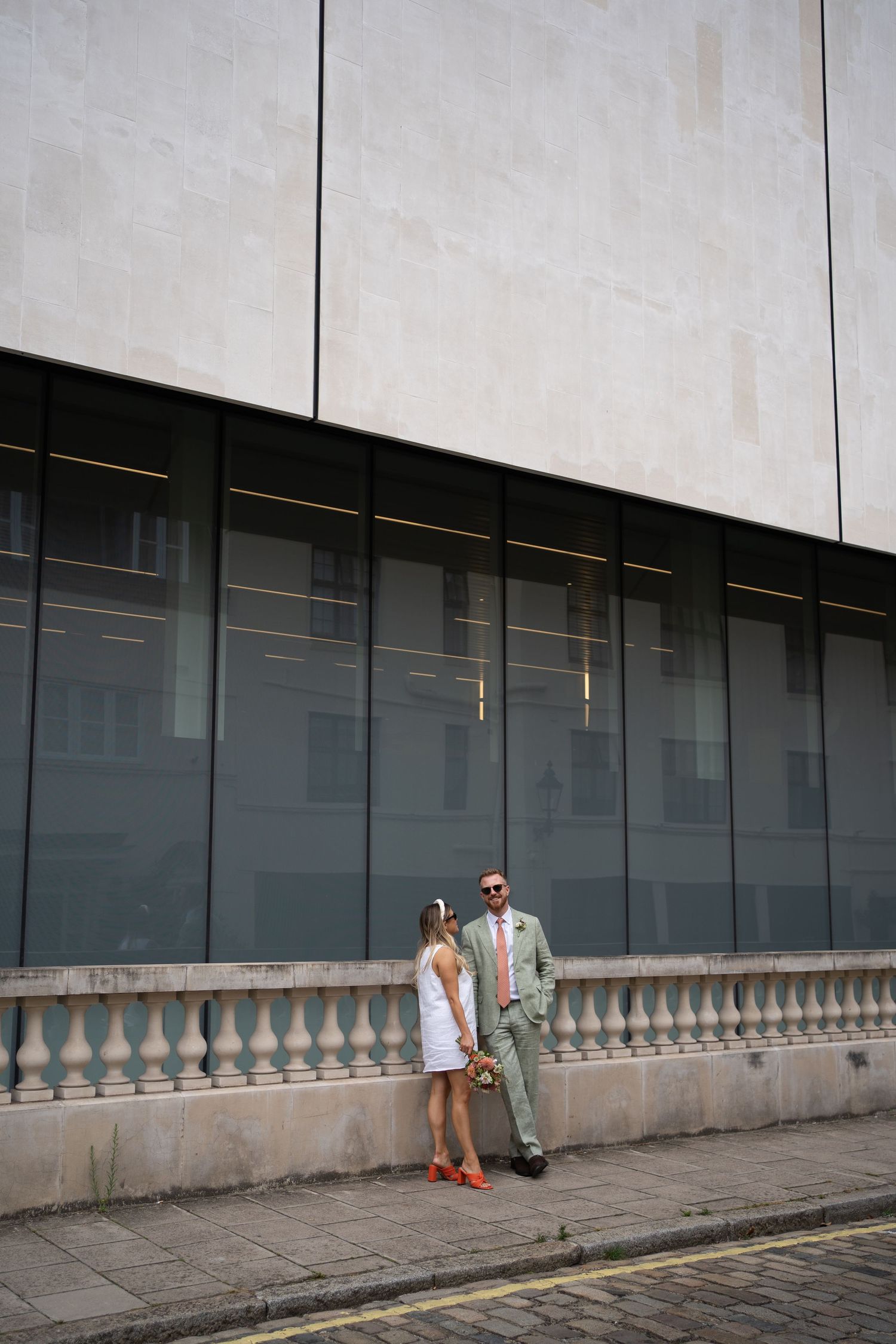 Modern architectural setting with minimalist concrete walls for wedding portraits.