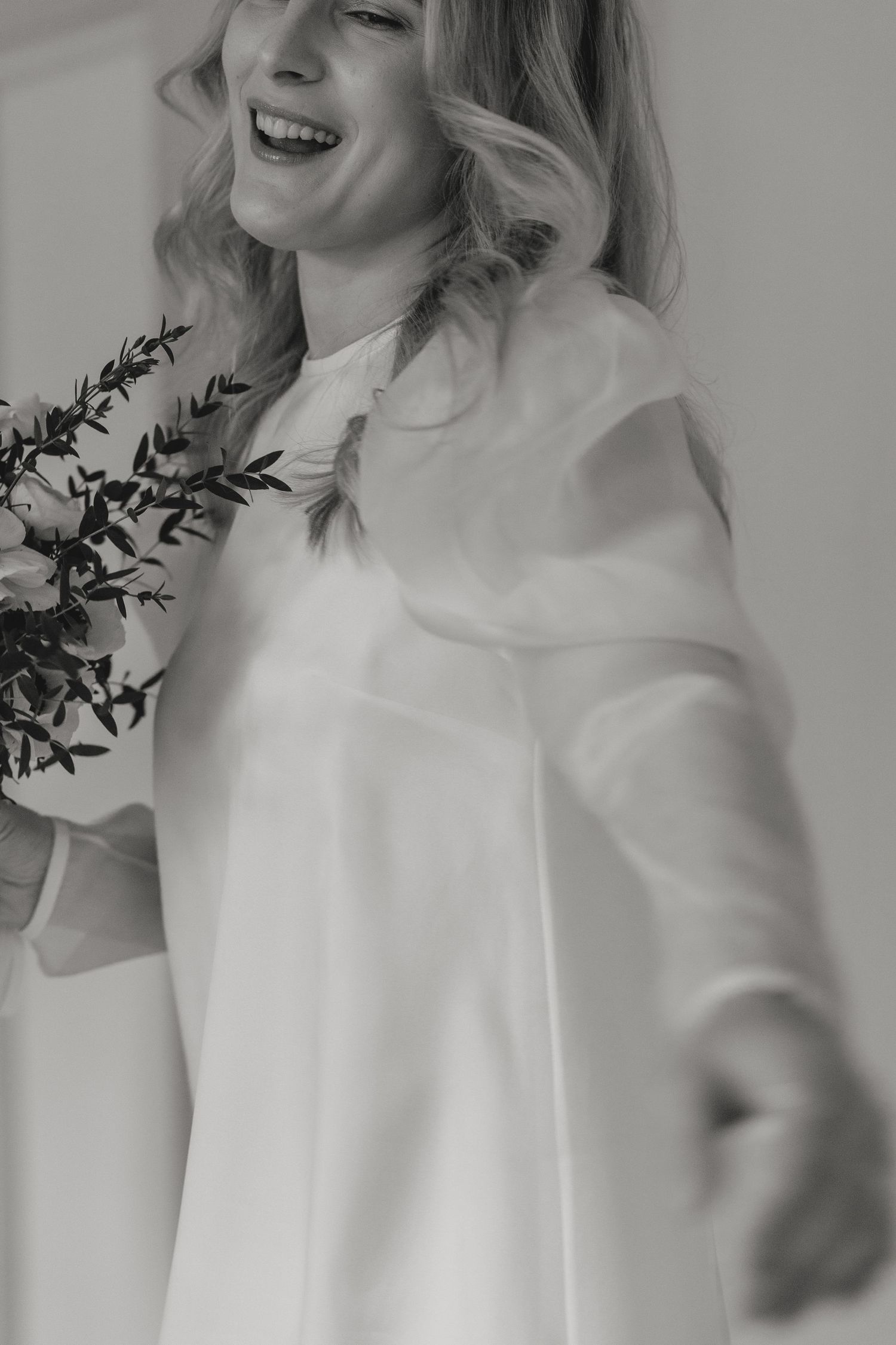 Artistic black and white portraits featuring someone in an elegant white top with flowing movement.