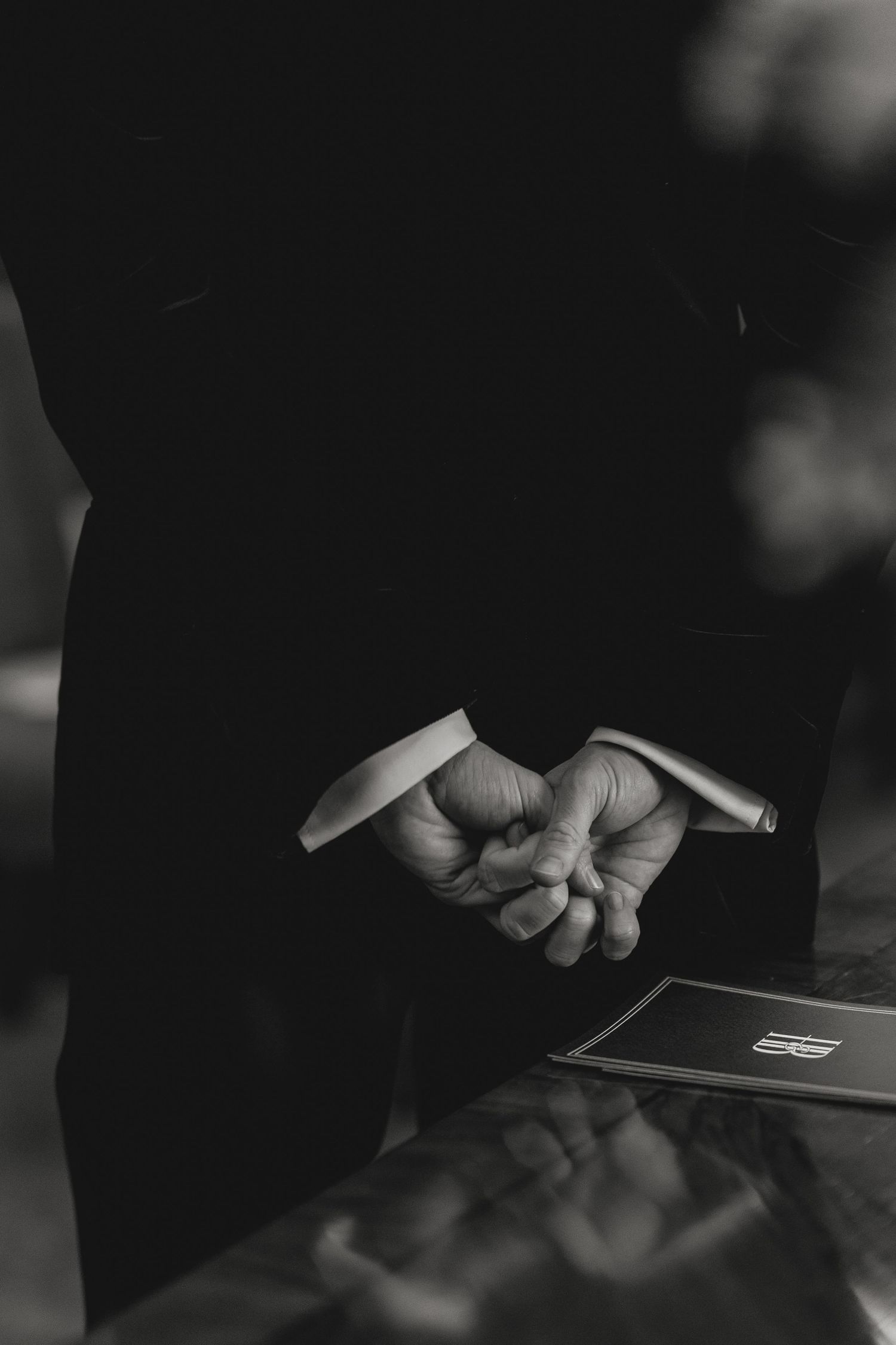 Close-up shot of hands holding documents during a formal ceremony.