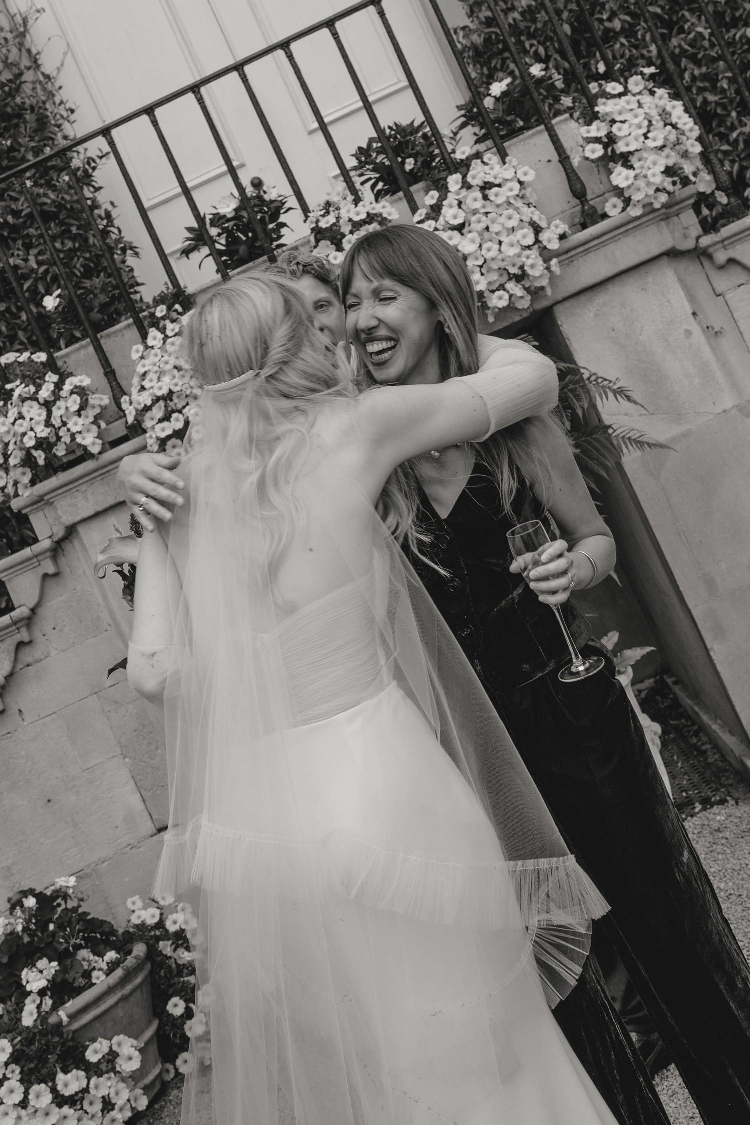Black and white candid moment of celebration at an outdoor event.