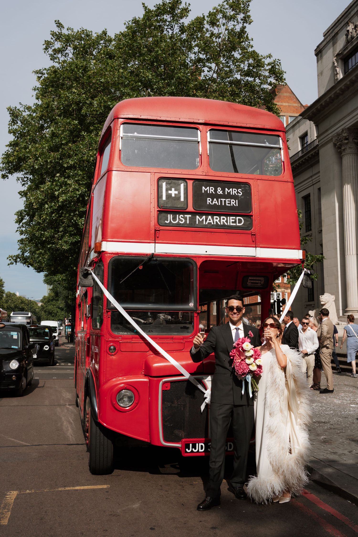 Classic red London double-decker bus decorated with 'Just Married' sign for wedding celebration.