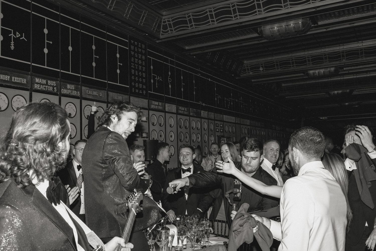 A dark nightclub interior filled with party-goers dancing and having fun.