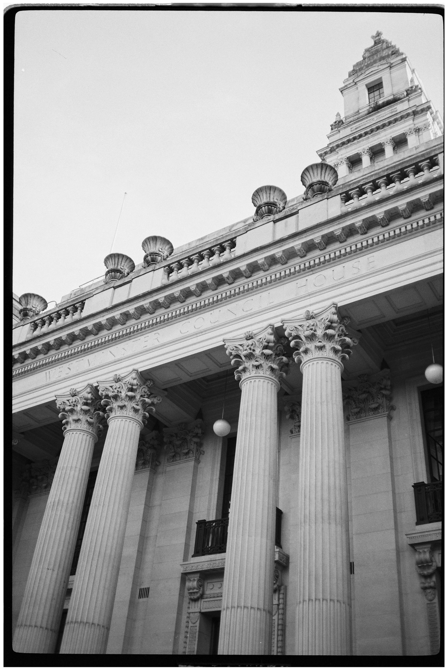 Classical building exterior with grand Corinthian columns in black and white.