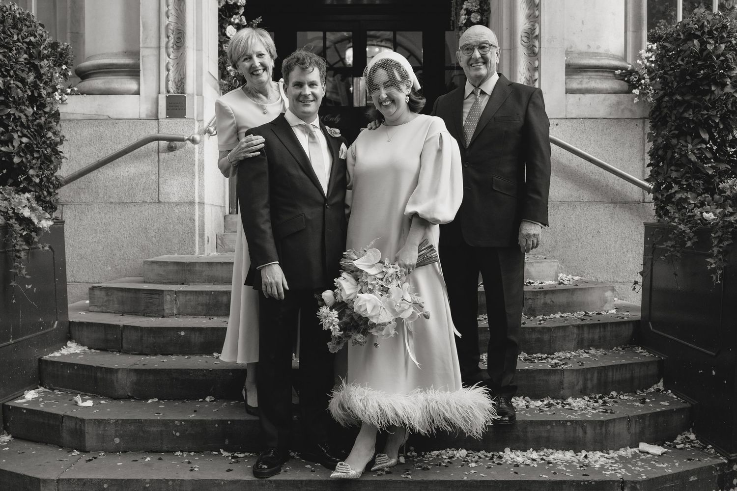 Black and white photograph showing people gathered on historic building steps.