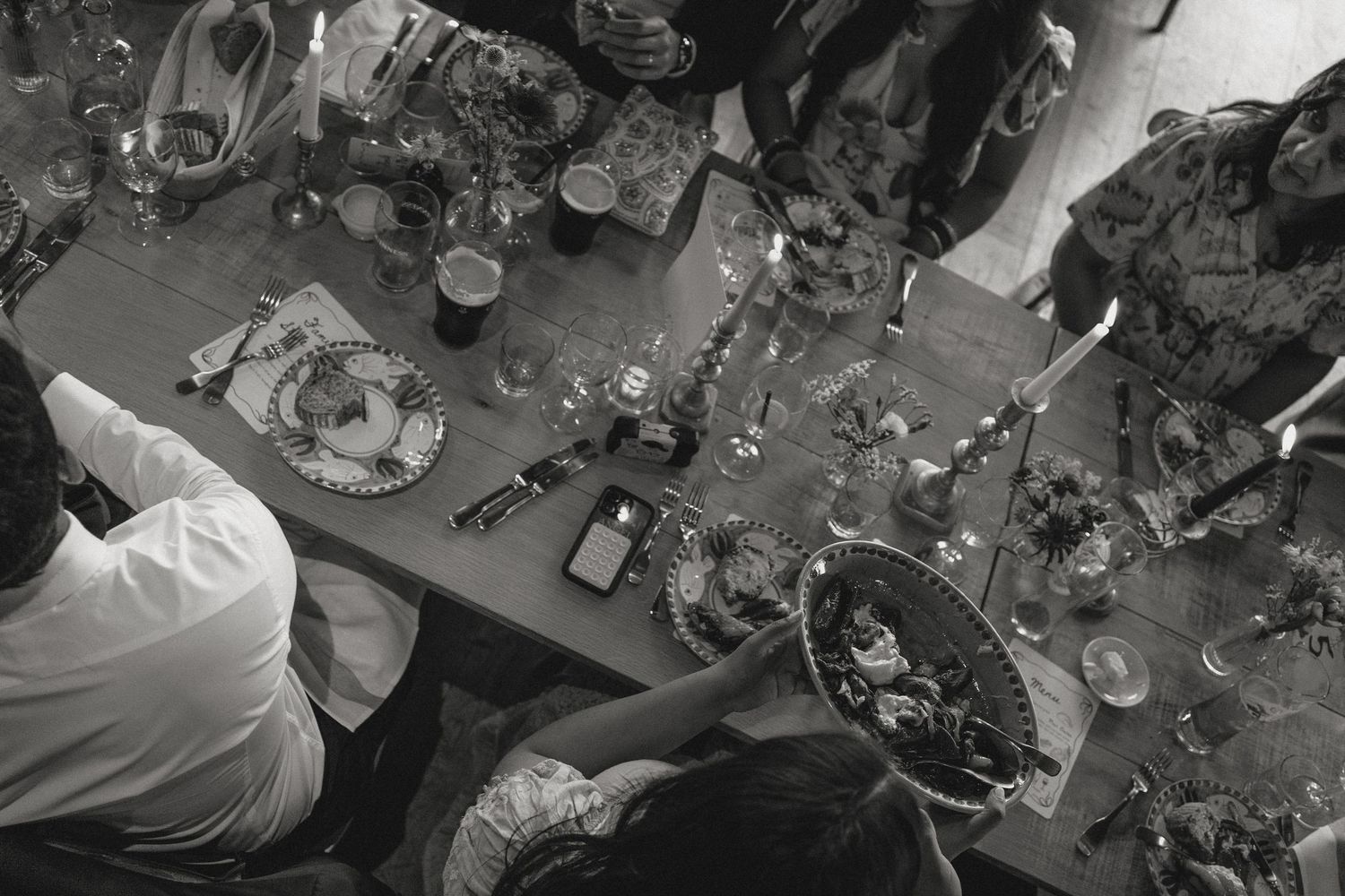 Overhead view of wedding reception tables decorated with floral centerpieces and place settings.