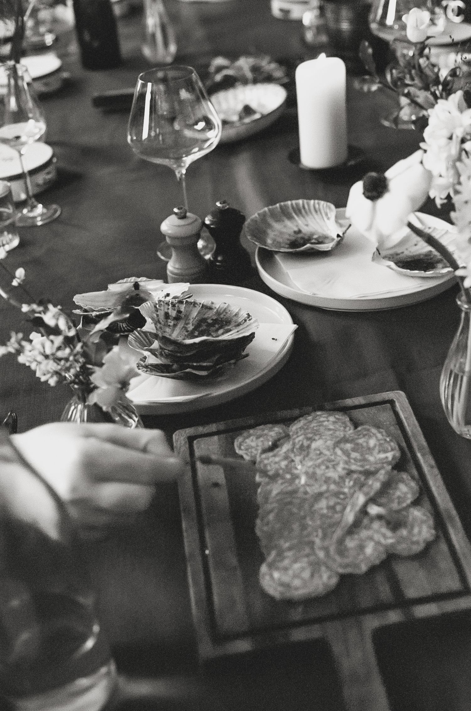 Elegant table setting with candles and place settings in black and white.