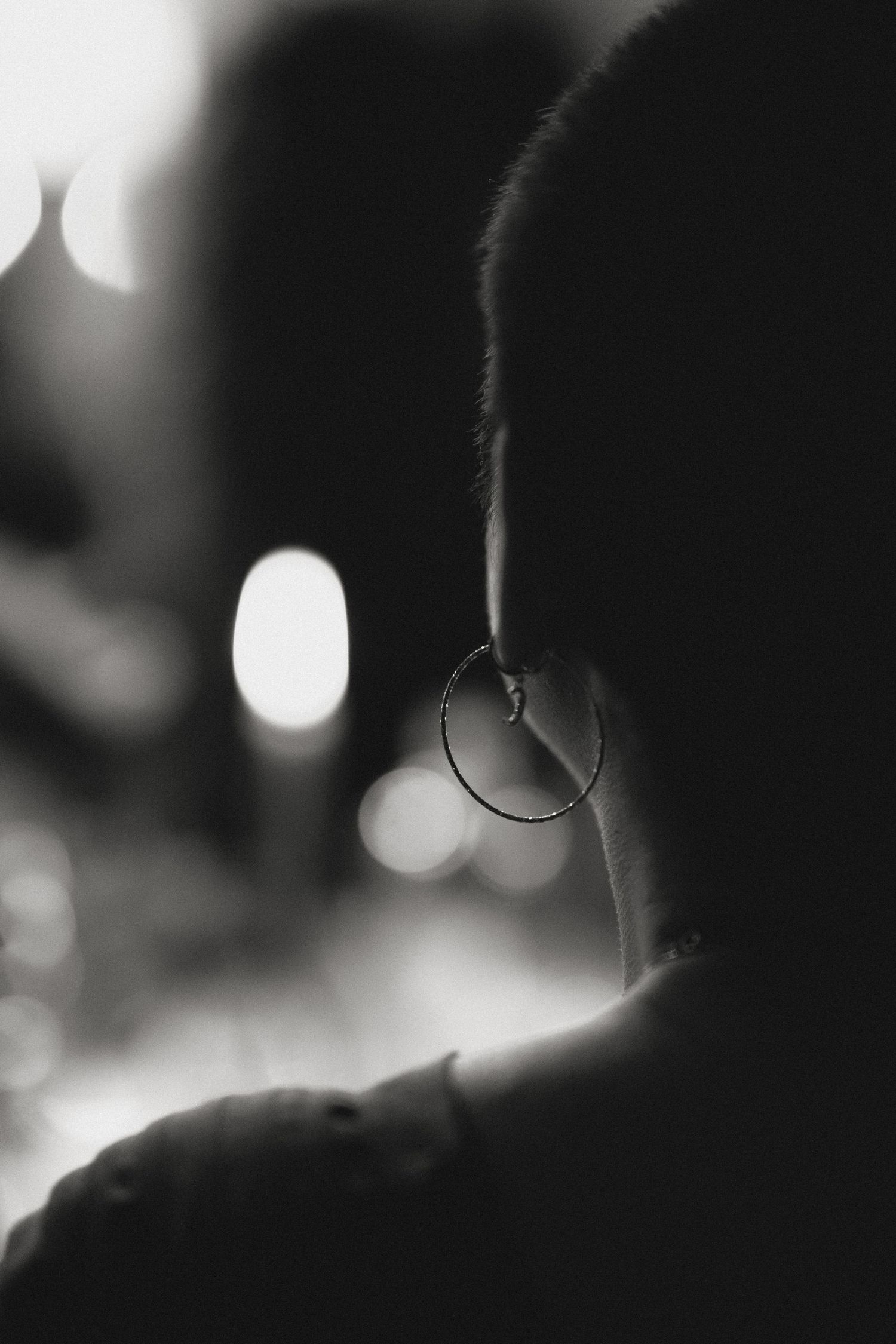 Dark silhouettes against a blurred background with soft bokeh lighting effects.