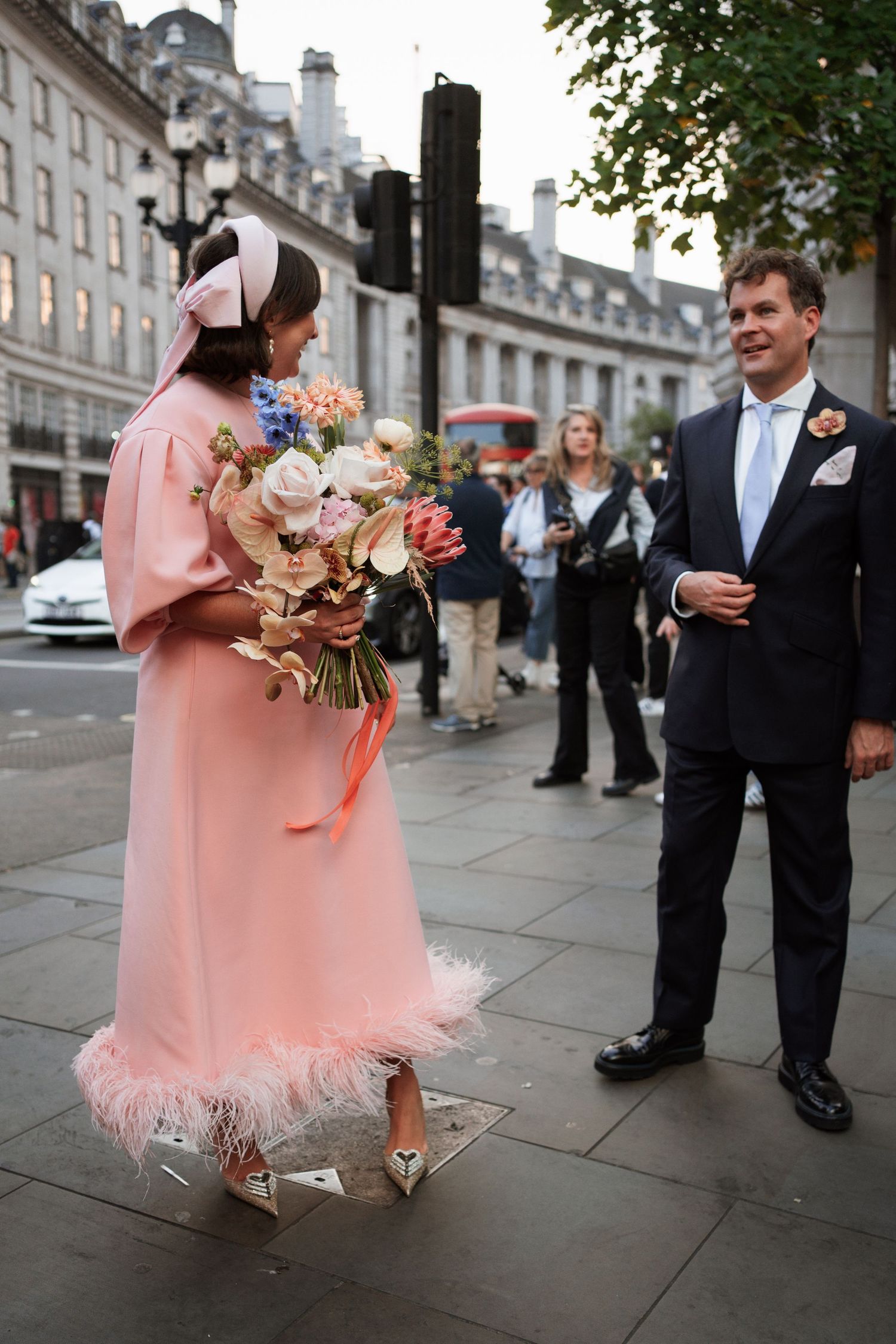 A pink dress with tulle skirt and bouquet captured in a series of street photos.