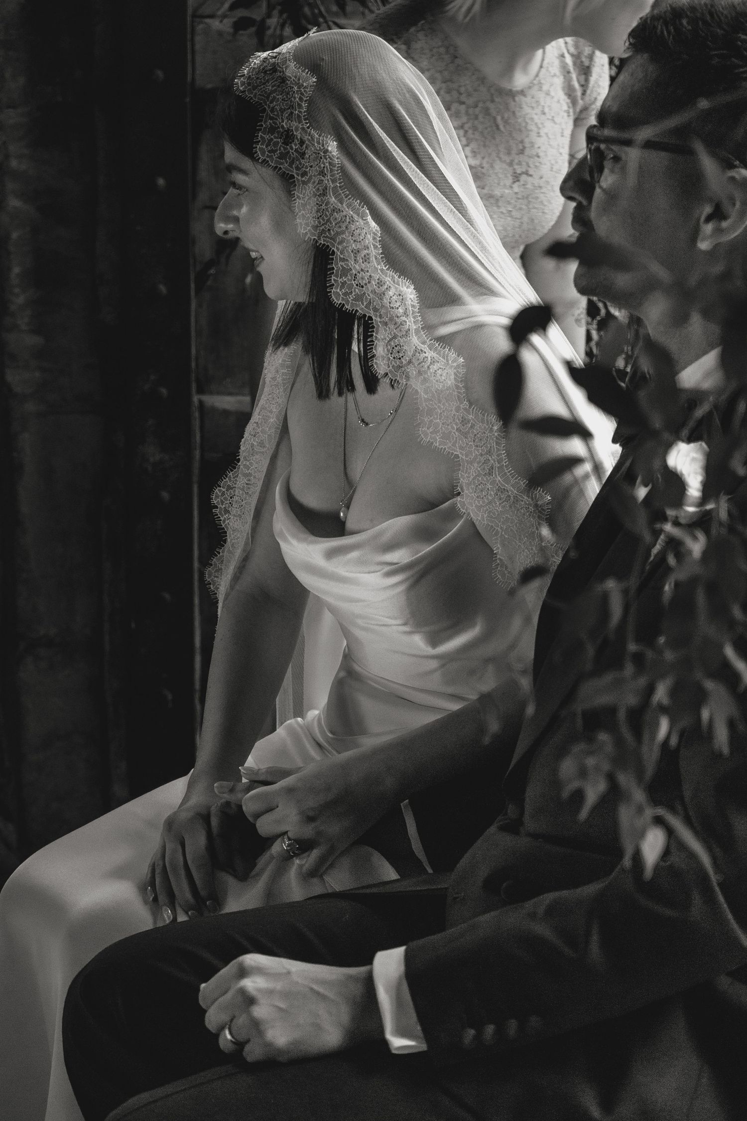 Black and white photograph of an intimate wedding ceremony moment.