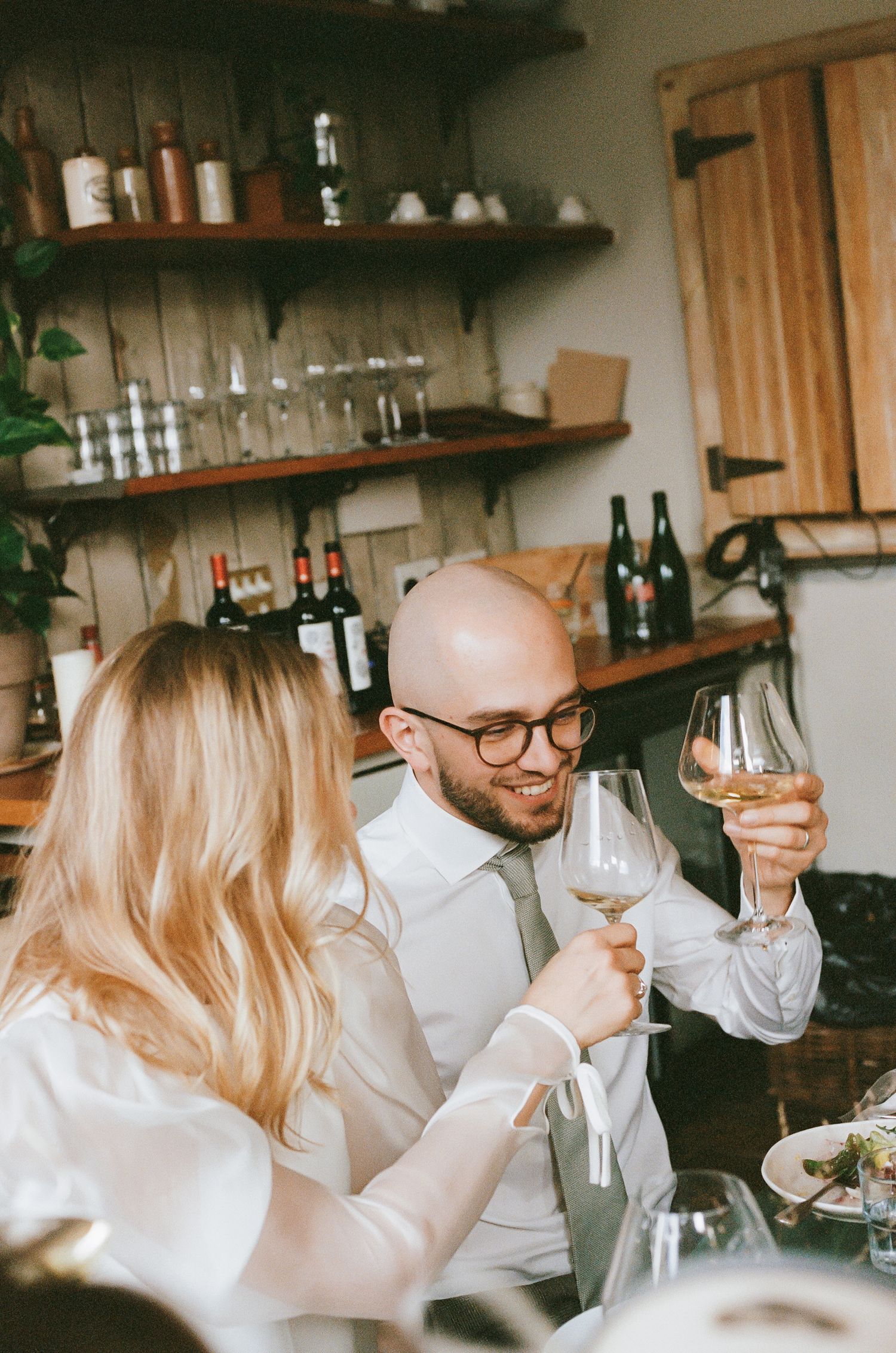 Guests enjoying wine tasting in a cozy restaurant setting.