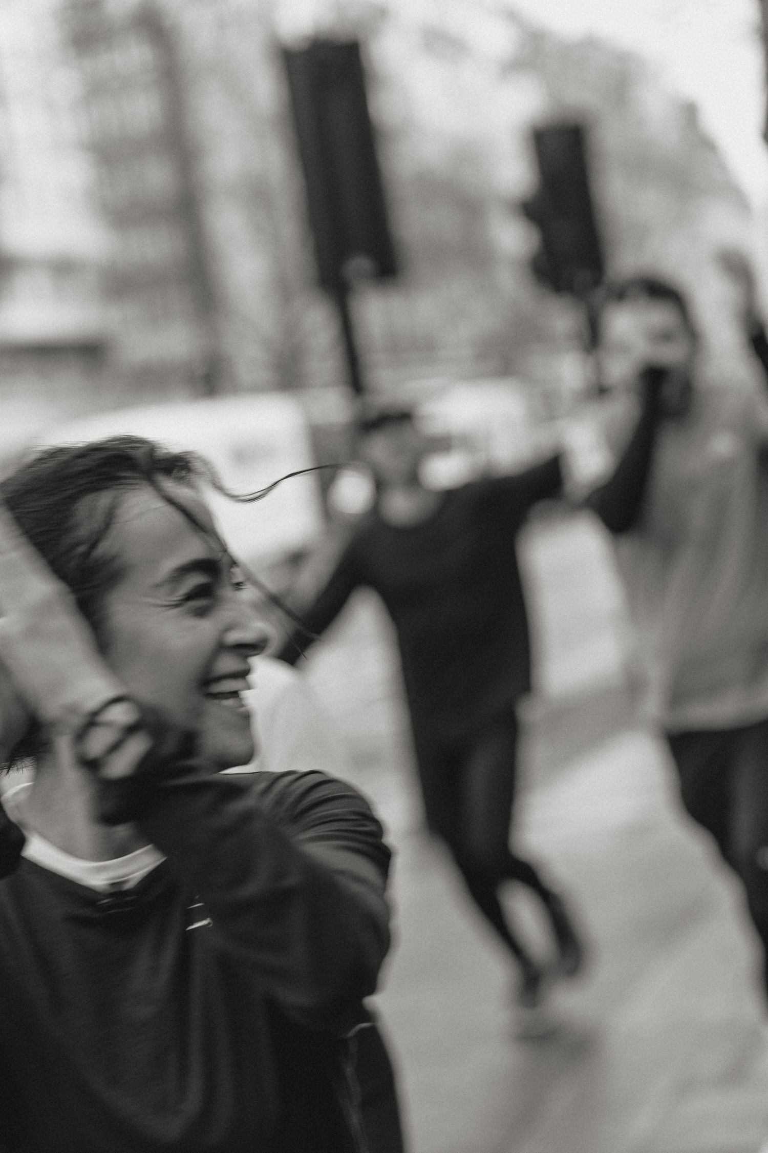 Black and white candid shots capturing spontaneous laughter and joy.