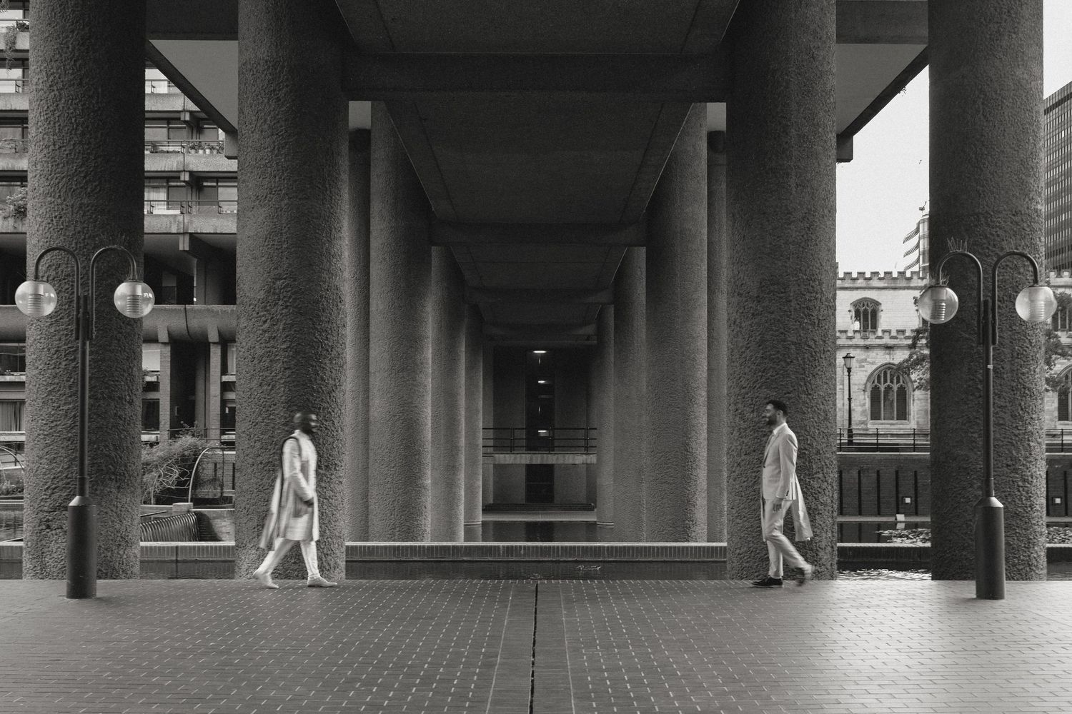 Row of concrete columns creating architectural perspective in urban setting.