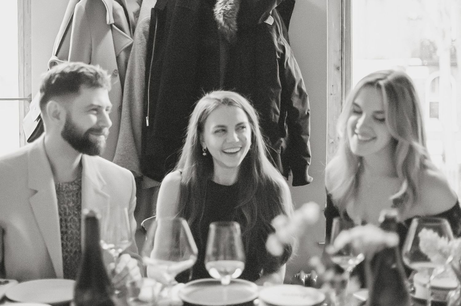 Wedding guests enjoying conversation at reception dinner table.