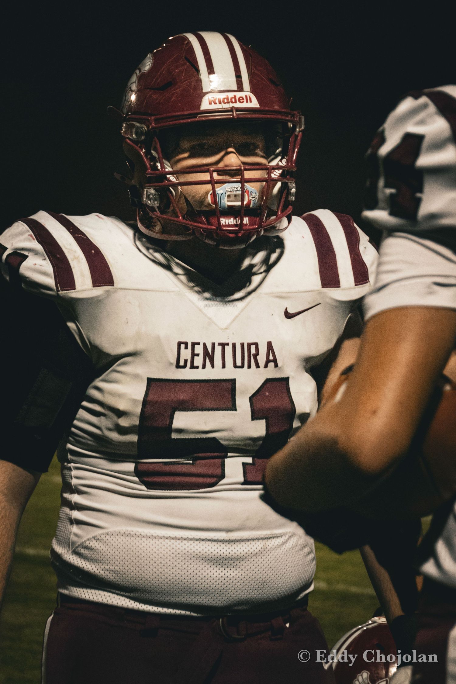 Close-up of football players wearing Centura team jerseys during game.