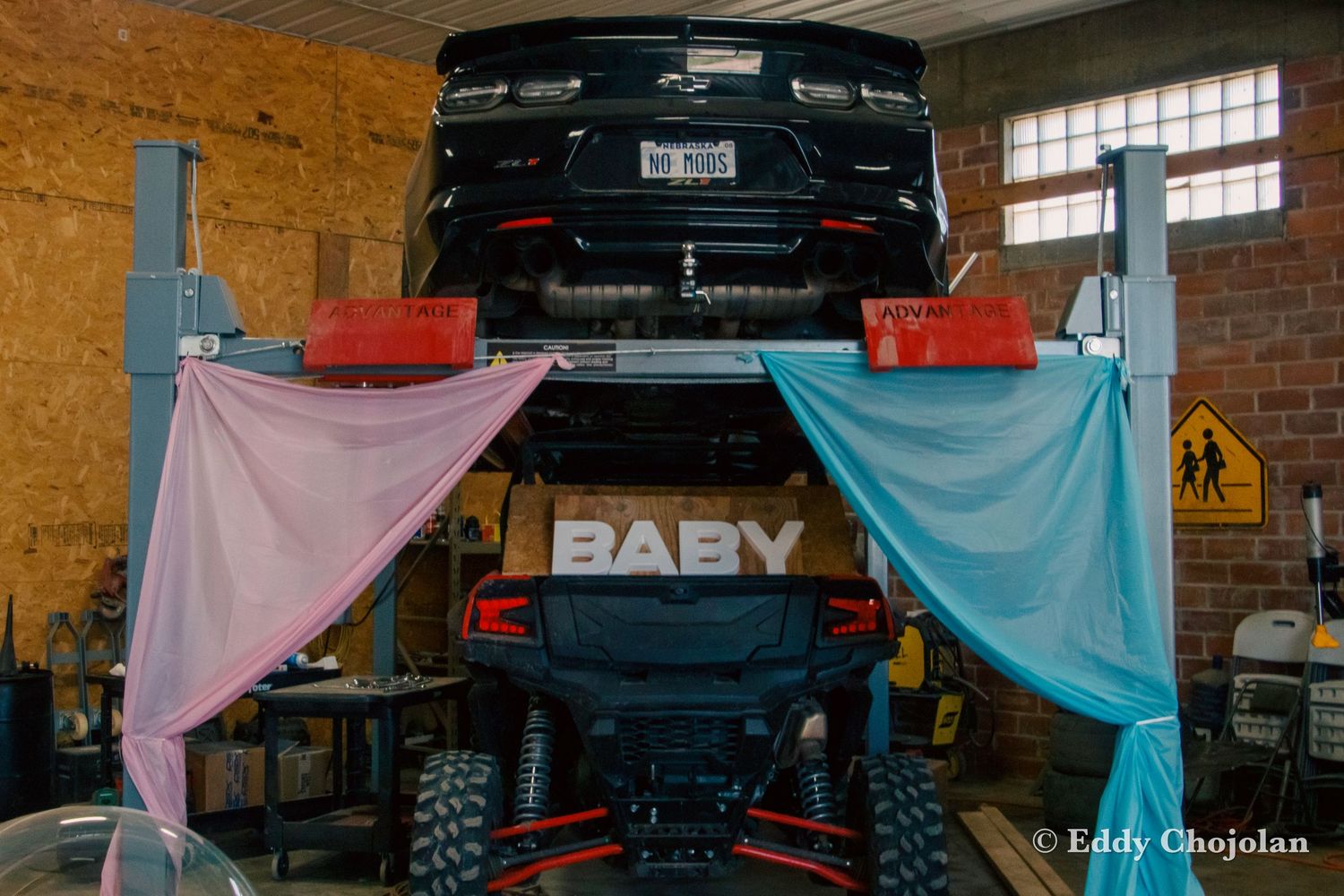 Lifted truck decorated with pink and blue fabric for a creative automotive-themed gender reveal.
