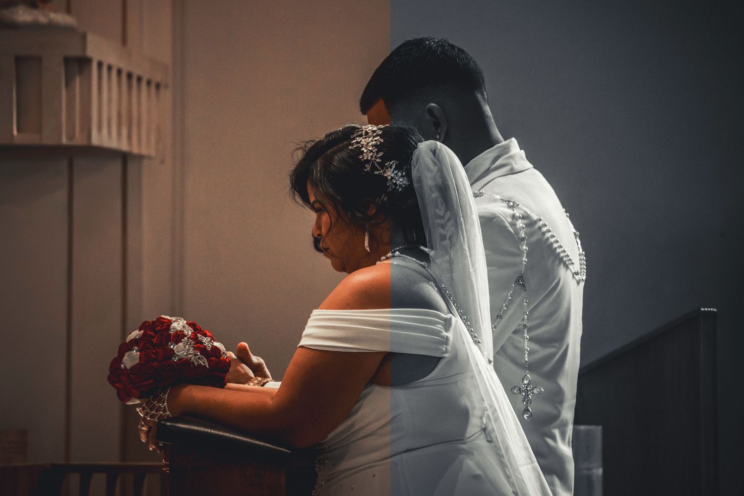 A side view of people in formal attire during an indoor ceremony.