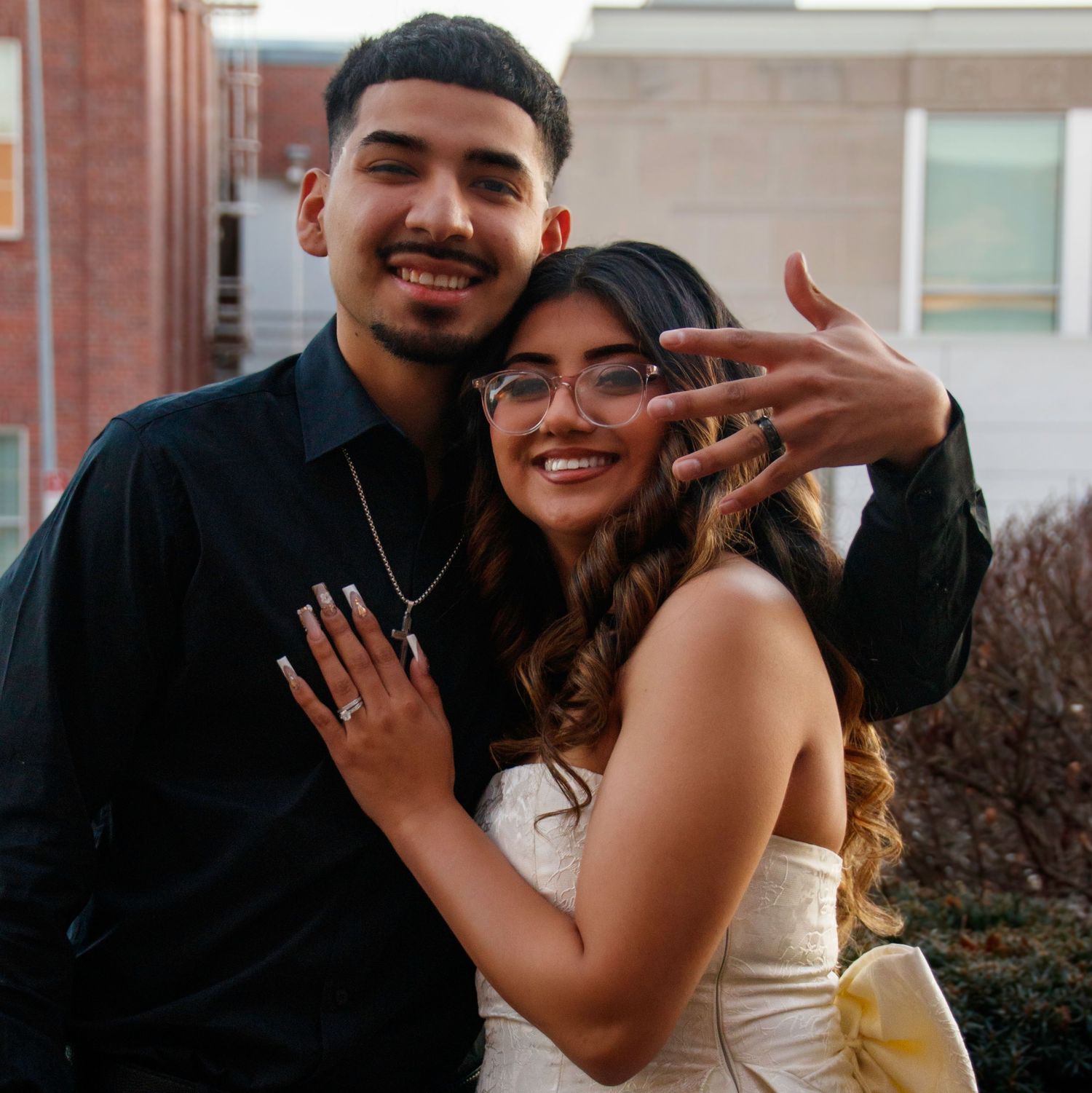 Wedding couple sharing joyful moments in multiple candid poses outside a brick building.