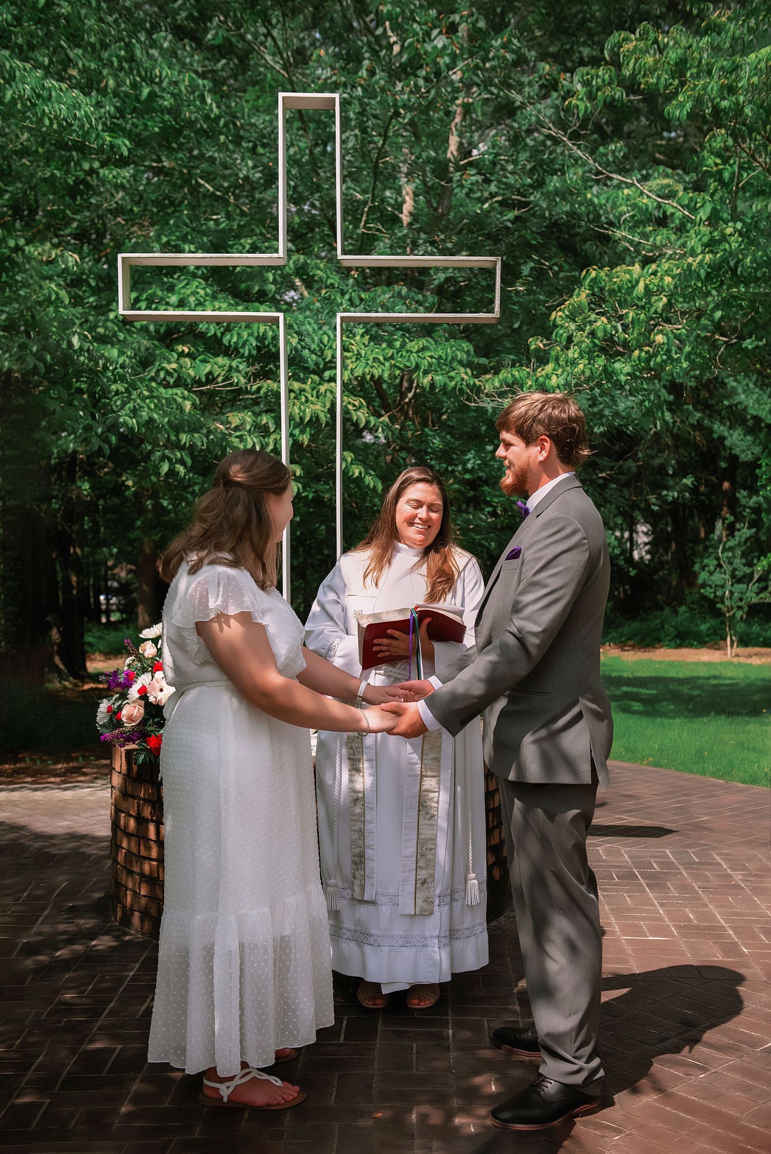 Groom & bride holding hands at altar during wedding ceremony; wedding photographer Lexington, SC; best wedding photographers Columbia, SC
