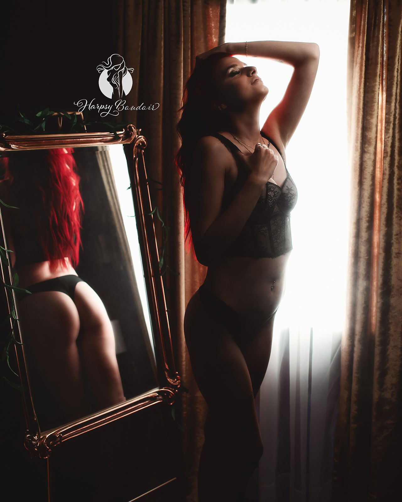 Boudoir photography in Lexington, SC, professional boudoir studio; sexy female in lingerie stands in front of mirror reflecting bare booty
