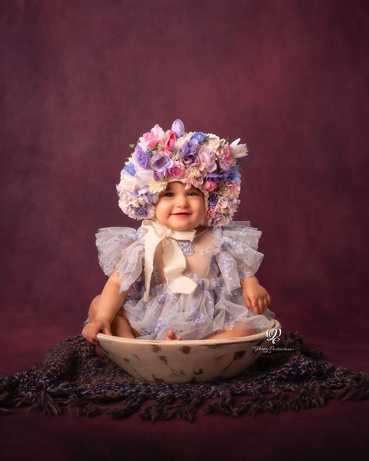 Baby girl sitter photography session with flower bonnet on purple backdrop; Lexington, SC studio photographer; baby phot