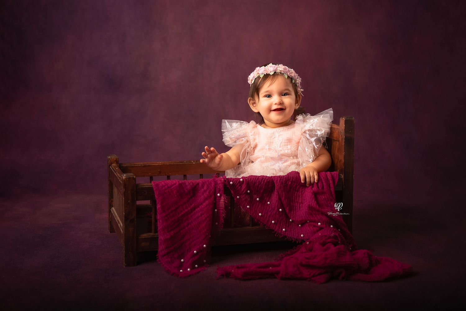 Baby girl sitter photoshoot; smiling baby toddler wearing pink tulle dress & flower headband during Sitter photography s