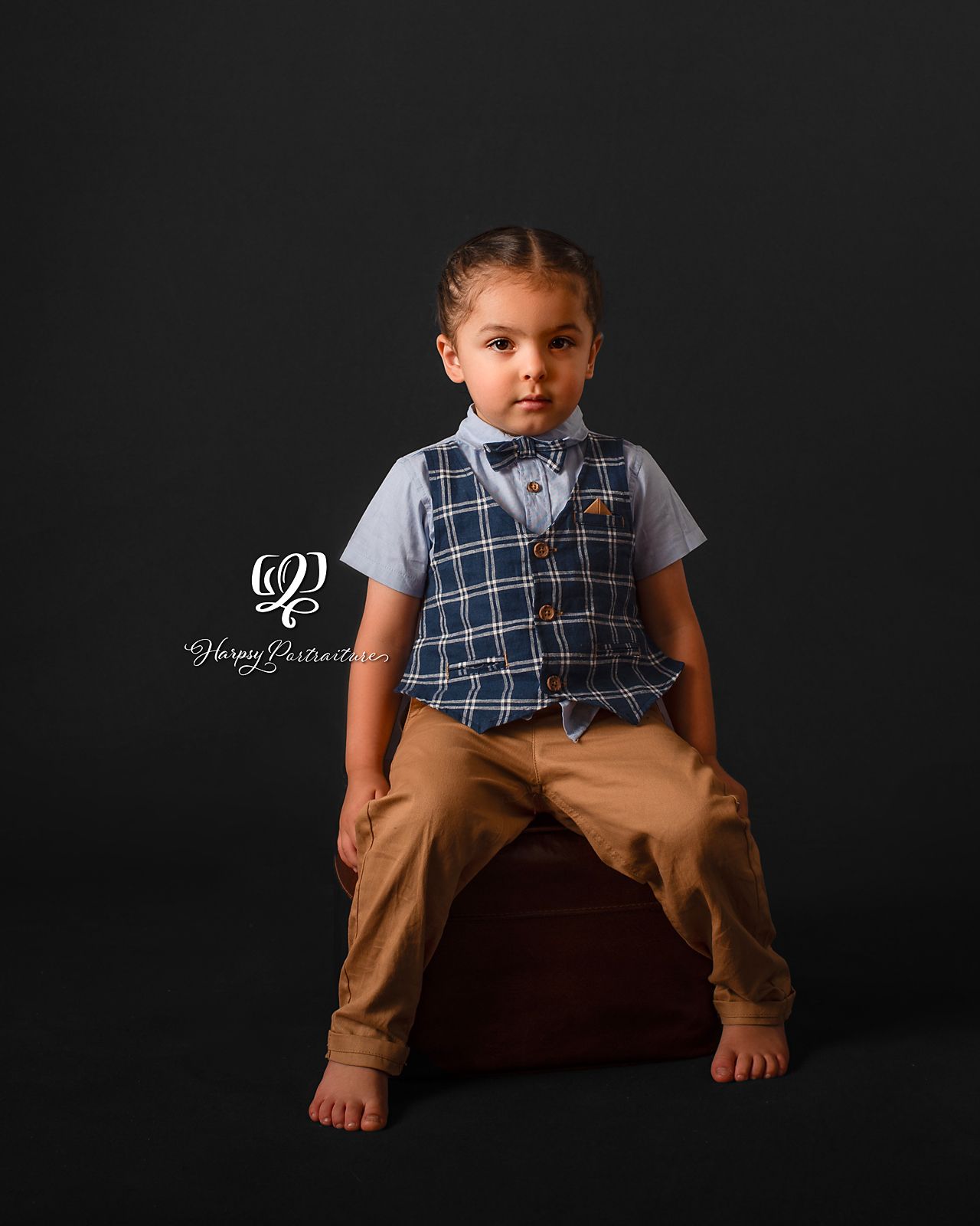 fine art children's photographer Lexington, SC; artistic photo of 2-year-old in vest & slacks with timeless expression; best photography